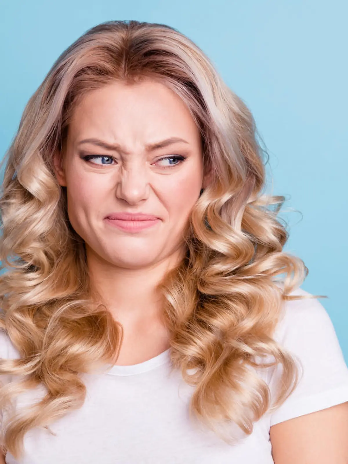Close up photo beautiful her she lady awful awkward situation look hate mad rage outraged ugh facial expression wear casual white t-shirt jeans denim clothes outfit isolated bright blue background.