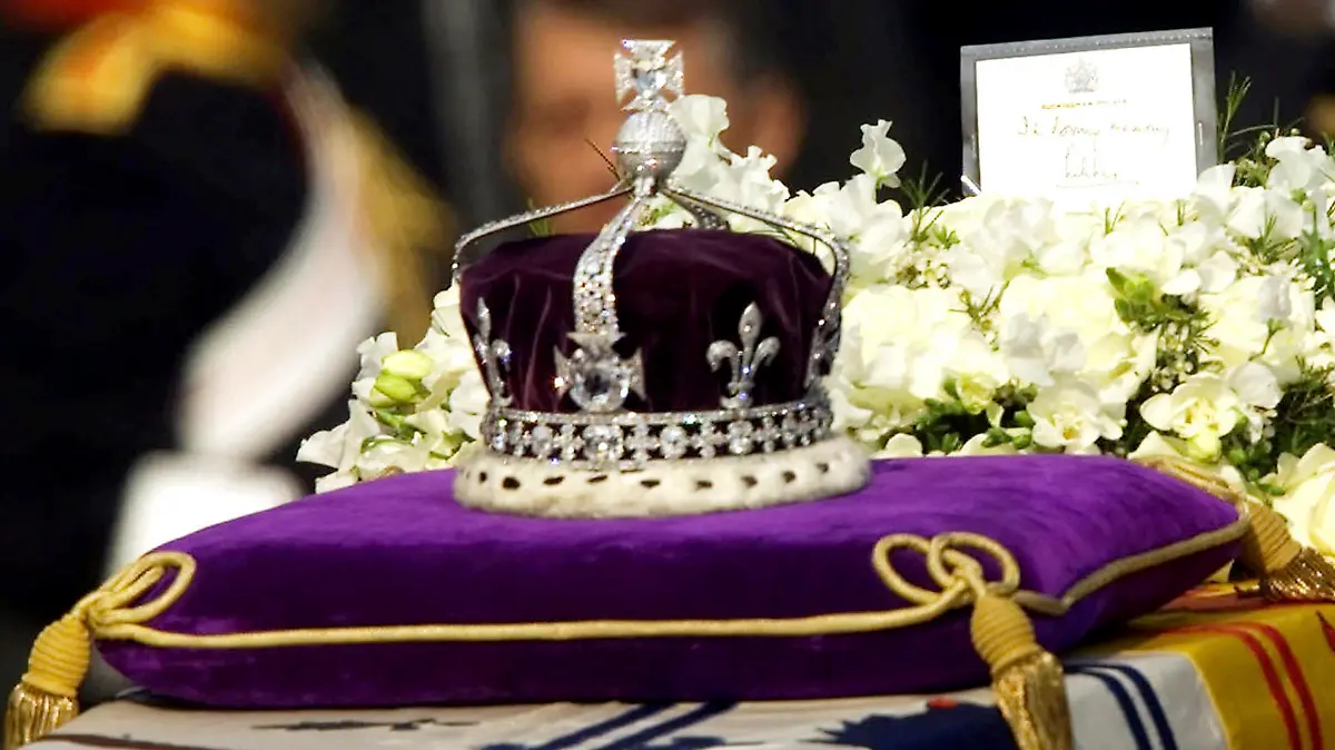 FILE- in this April 5, 2002 file photo, The Koh-i-noor, or "mountain of light," diamond, set in the Maltese Cross at the front of the crown made for Britain's late Queen Mother Elizabeth, is seen on her coffin, along with her personal standard, a wreath and a note from her daughter, Queen Elizabeth II, as it is drawn to London's Westminster Hall. India's government has told the country's top court it won't try to reclaim the 106-carat Koh-i-Noor diamond, which is now part of the British crown jewels.The government told the Supreme Court on Monday that the diamond was neither taken away forcibly nor stolen, but was given as a gift to Queen Victoria by an Indian king in the mid-19th century. (AP Photo/Alastair Grant, File)