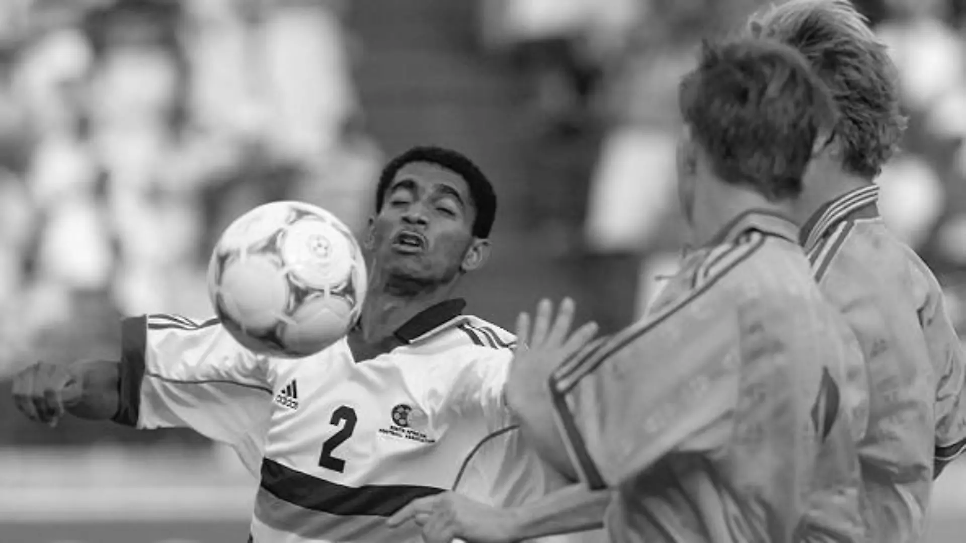 South African defender Papi Khomane (L) receives the ball and is challenged by two Swedish players (R) during a friendly soccer match between South Africa and Sweden at Lofthus stadium in Pretoria, 27 November 1999. South Africa won 1-0. (ELECTRONIC IMAGE) AFP PHOTO (Photo by Odd ANDERSEN / AFP) (Photo by ODD ANDERSEN/AFP via Getty Images)