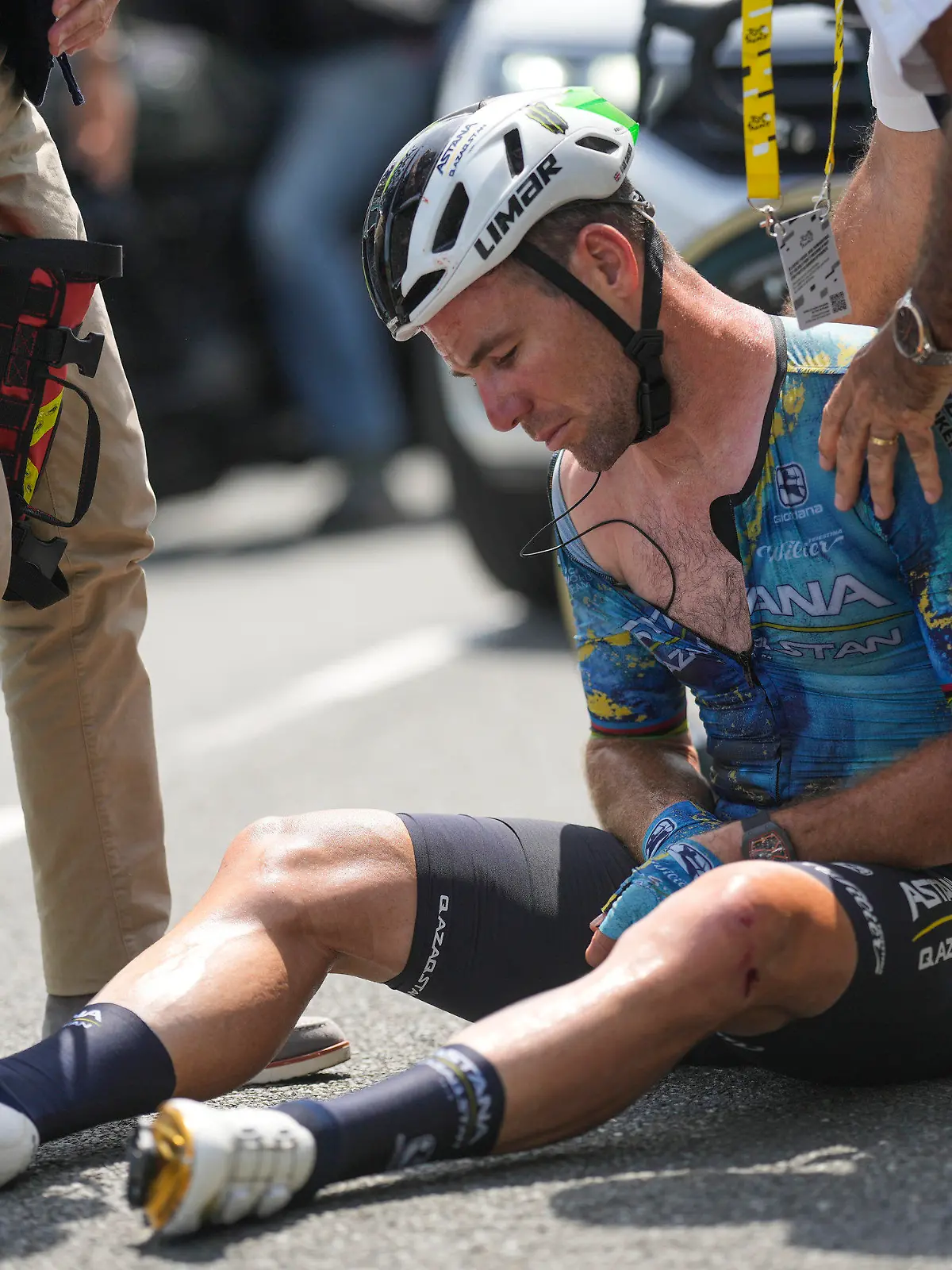 Britain's Mark Cavendish receives medical assistance after crashing during the eighth stage of the Tour de France cycling race over 201 kilometers (125 miles) with start in Libourne and finish in Limoges, France, Saturday, July 8, 2023. (AP Photo/Thibault Camus)