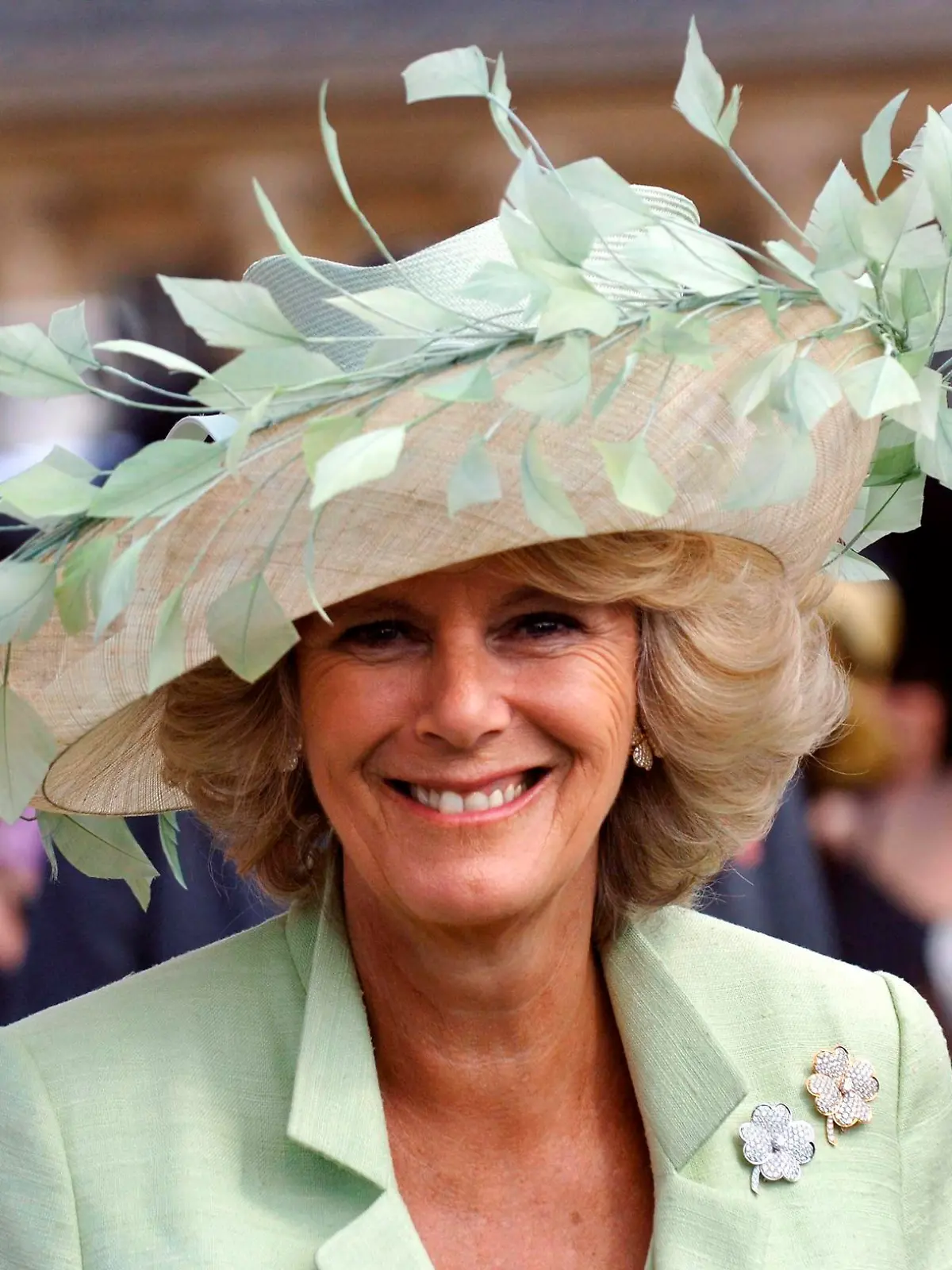 FILE - Britian's Camilla, The Duchess of Cornwall attends her first garden party since her marriage to the Prince of Wales, at Buckingham Palace in London, Tuesday July 19, 2005. Camilla is wearing a hat by Irish milliner Philip Treacy. After seven decades, the United Kingdom has a new woman to call queen. Camilla, Duchess of Cornwall, will be known as Queen Consort, a title that came with Queen Elizabeth II’s blessing after many years of contention, dating back to the years before she even married Prince Charles. (Fiona Hanson, Pool Photo via AP, FIle)