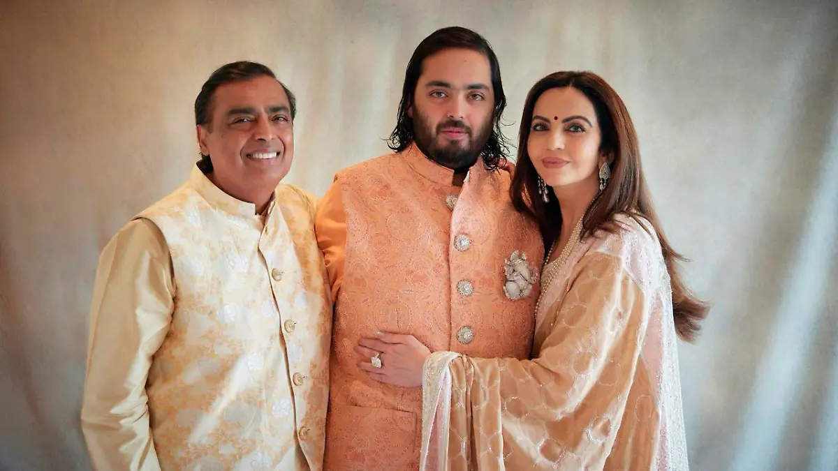 This photograph released by the Reliance group shows from L to R, billionaire industrialist Mukesh Ambani, son Anant and wife Nita, posing for a photograph as guests gather to celebrate Anant's wedding in Jamnagar, India, Saturday, Mar. 02, 2024. (Reliance group via AP)