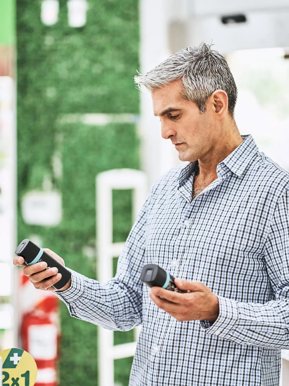 Mature male customer choosing medicines at pharmacy. Man buying medicine at pharmacy store.