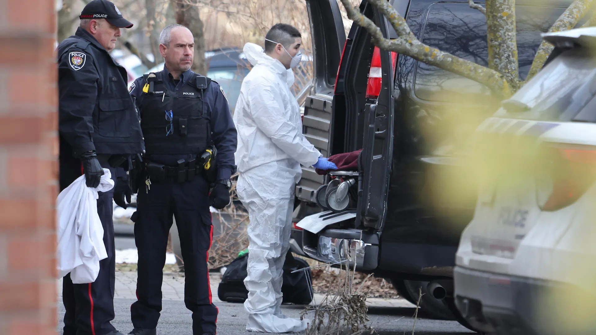 A member of the coroner's office moves a stretcher at the scene of a homicide where six people were found dead in the Barrhaven suburb of Ottawa on Thursday, March 7, 2024. (Patrick Doyle /The Canadian Press via AP)