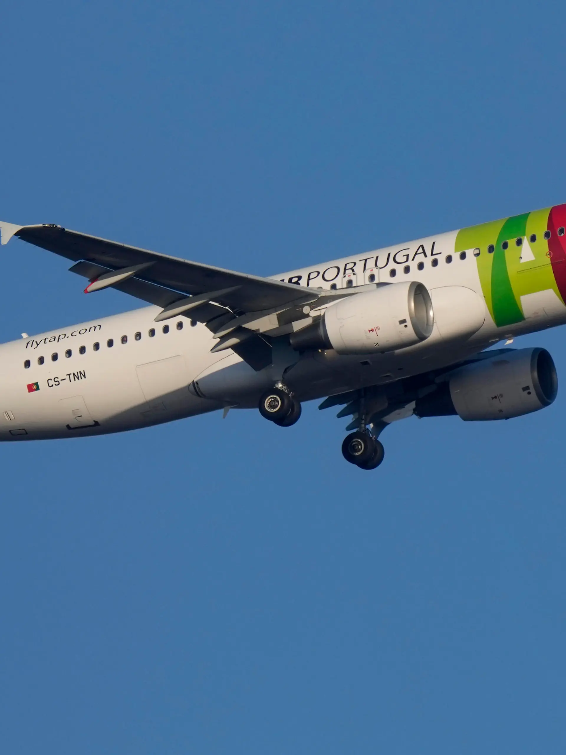 A TAP Air Portugal Airbus A320 approaches for landing in Lisbon early in the morning, Saturday, May 7, 2022. (AP Photo/Armando Franca)