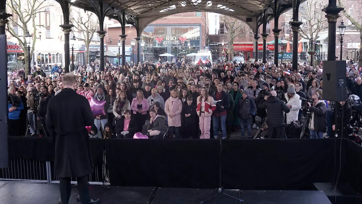 People, many wearing pink, attend a vigil for16-year-old Brianna Ghey in Golden Square to mark the first anniversary of the teenager's death, in Warrington, England, Sunday, Feb. 11, 2024. (Danny Lawson/PA via AP)