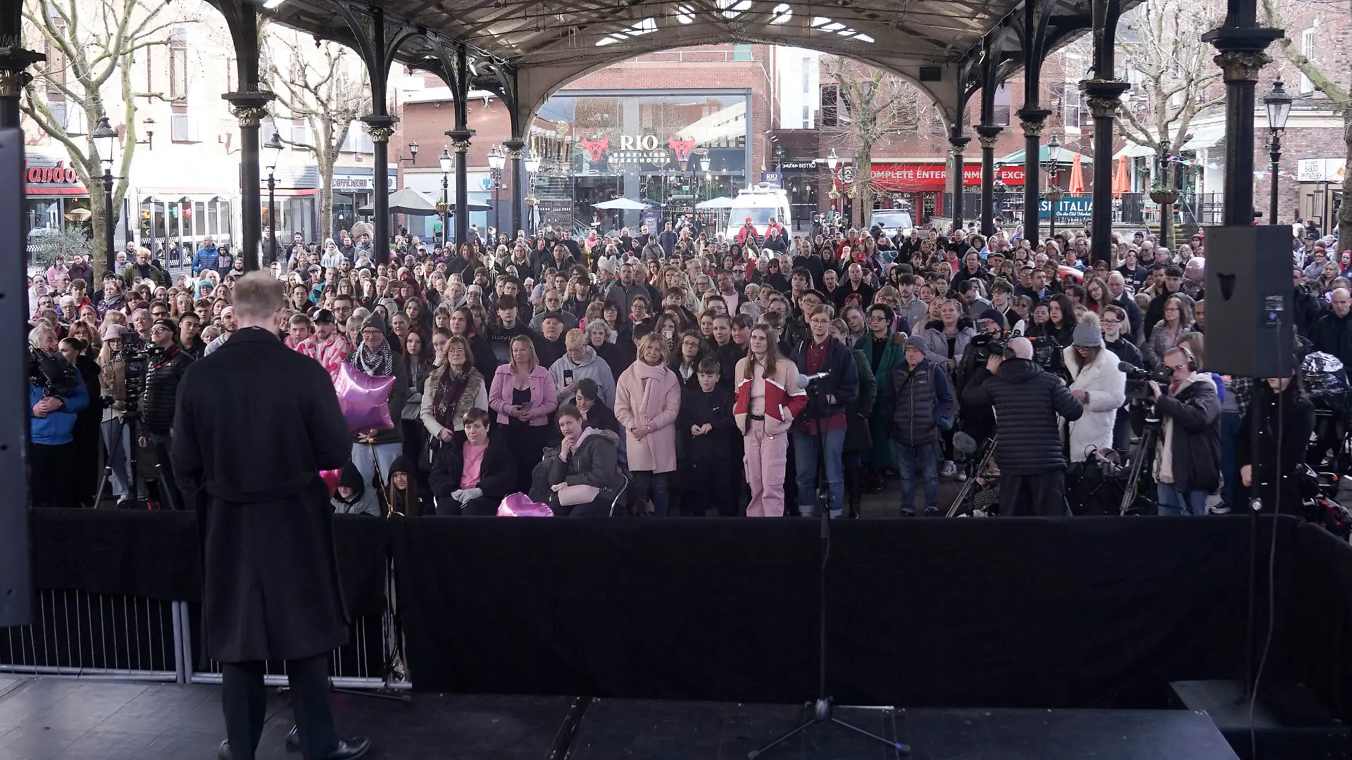 People, many wearing pink, attend a vigil for16-year-old Brianna Ghey in Golden Square to mark the first anniversary of the teenager's death, in Warrington, England, Sunday, Feb. 11, 2024. (Danny Lawson/PA via AP)