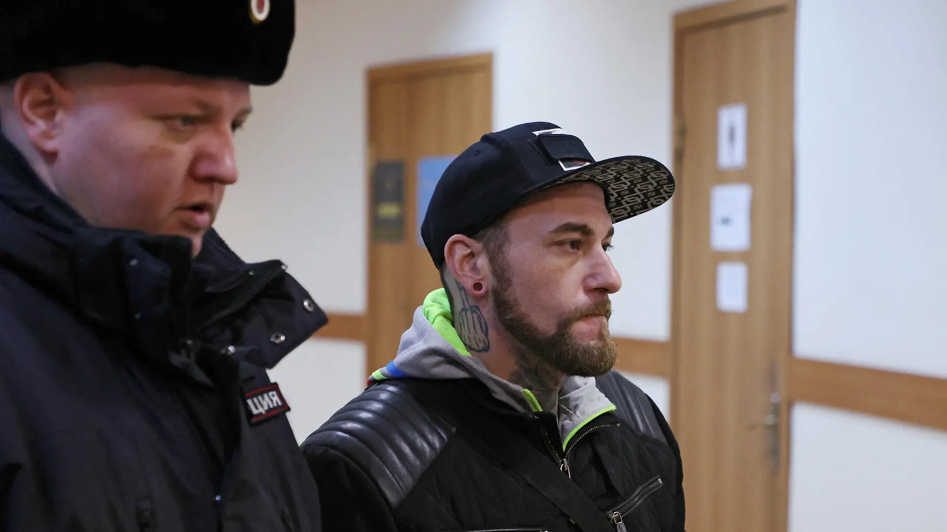  SENSITIVE MATERIAL. THIS IMAGE MAY OFFEND OR DISTURB    Patrick Schobel, a German national suspected of drug smuggling after he was detained at Pulkovo airport with gummy candies containing cannabis, is escorted before a court hearing in Saint Petersburg, Russia March 12, 2024. REUTERS/Anton Vaganov