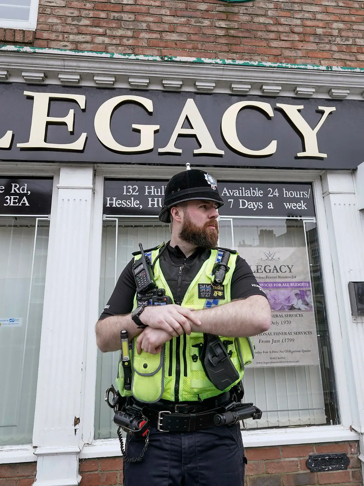 Police  stand guard outside the Beckside branch of Legacy Independent Funeral Directors, in Hull, England, Saturday, March 9, 2024. Police in northern England say they have removed 34 bodies from a funeral home and arrested a man and woman on suspicion of fraud and preventing lawful burials. The arrests Sunday follow several days of investigation at Legacy Funeral Directors in Hull and two related funeral homes. (Danny Lawson/PA via AP)