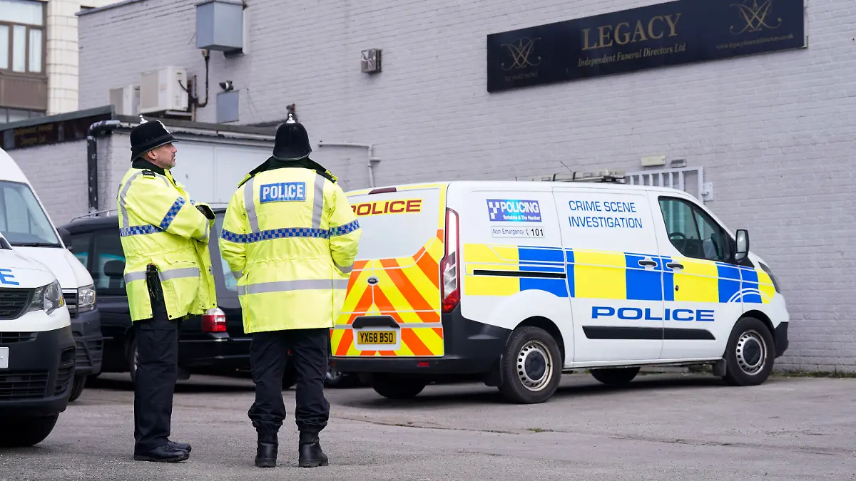 Police stand outside the Hessle Road branch of Legacy Independent Funeral Directors in Hull, England, Saturday, March 9, 2024. Police in northern England say they have removed 34 bodies from a funeral home and arrested a man and woman on suspicion of fraud and preventing lawful burials. The arrests Sunday follow several days of investigation at Legacy Funeral Directors in Hull and two related funeral homes. (Danny Lawson/PA via AP)