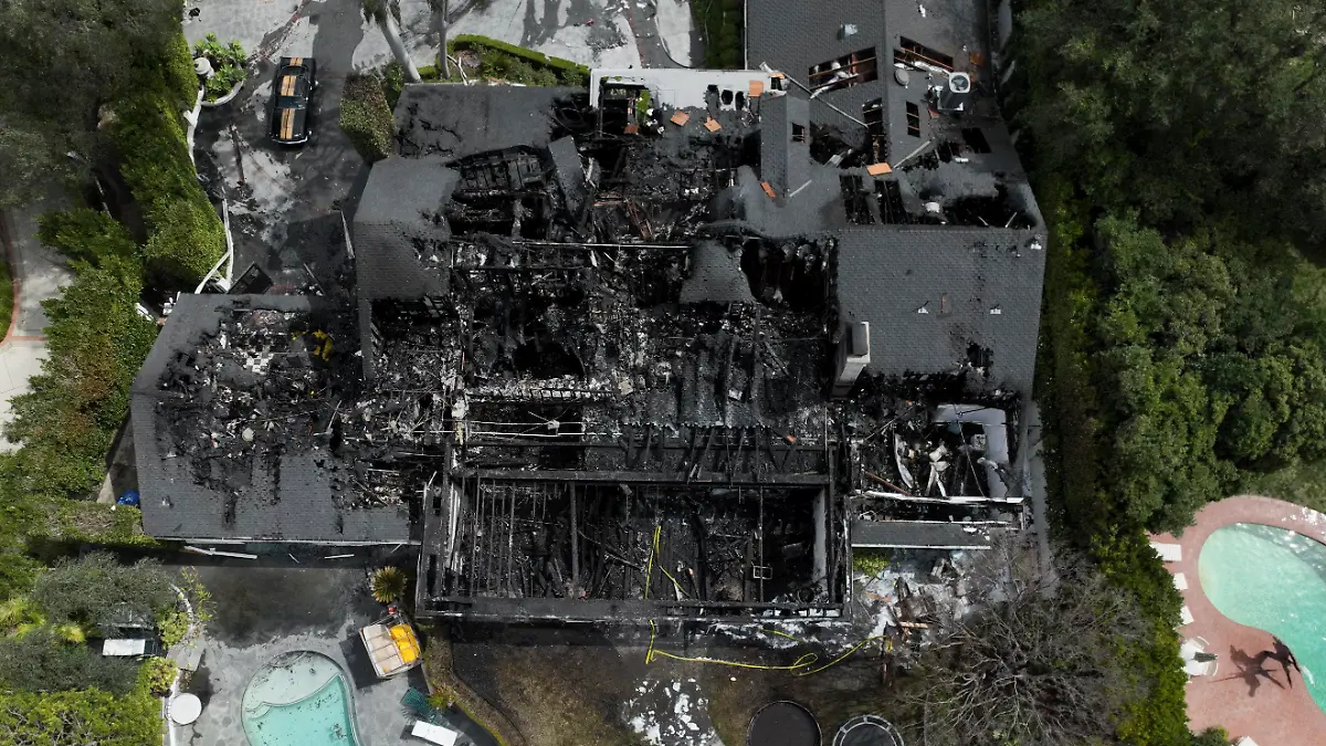 An aerial view shows a fire-damaged property, which appears to belong to Cara Delevingne, Friday, March 15, 2024, in the Studio City section of Los Angeles. (AP Photo/Jae C. Hong)