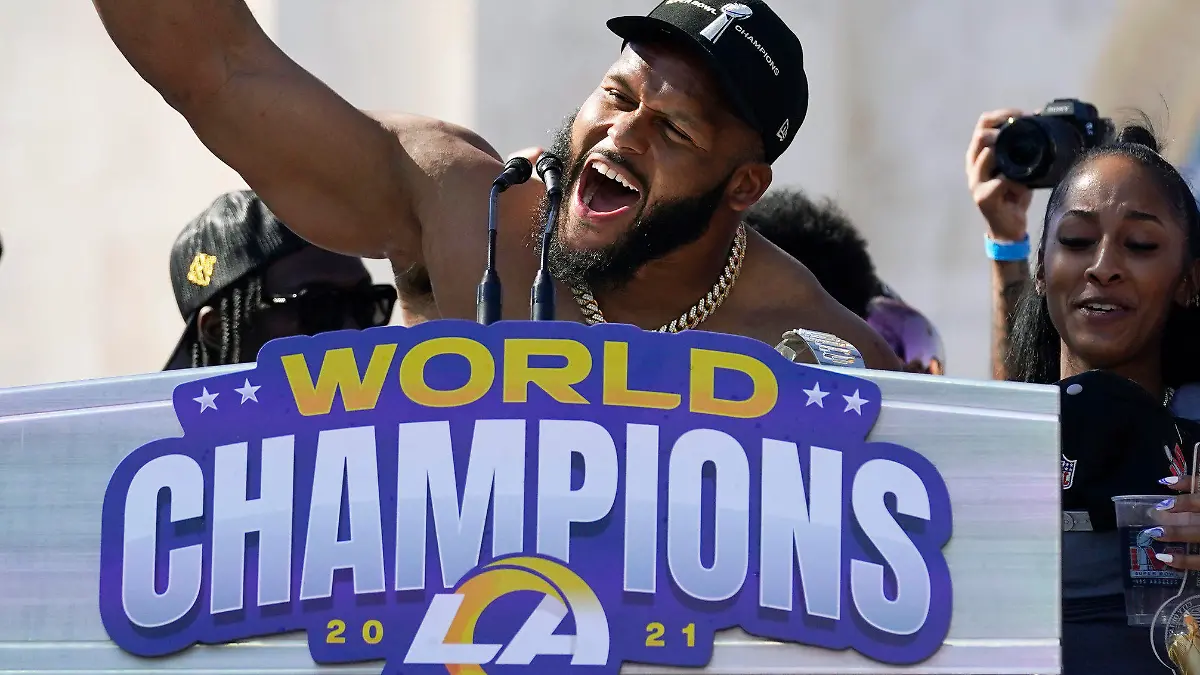 FILE - Los Angeles Rams defensive lineman Aaron Donald holds up the Vince Lombardi Super Bowl trophy during the team's victory celebration and parade in Los Angeles, Wednesday, Feb. 16, 2022. Defensive lineman Aaron Donald has announced his retirement after a standout 10-year career with the Los Angeles Rams. The three-time AP NFL Defensive Player of the Year made his surprising announcement on social media Friday, March 15, 2024. (AP Photo/Marcio Jose Sanchez)