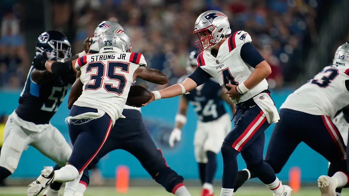 Aug 25, 2023; Nashville, Tennessee, USA; New England Patriots quarterback Bailey Zappe (4) hands the ball to running back Pierre Strong Jr. (35) during the third quarter against the New England Patriots at Nissan Stadium. Mandatory Credit: Andrew Nelles-USA TODAY Sports
