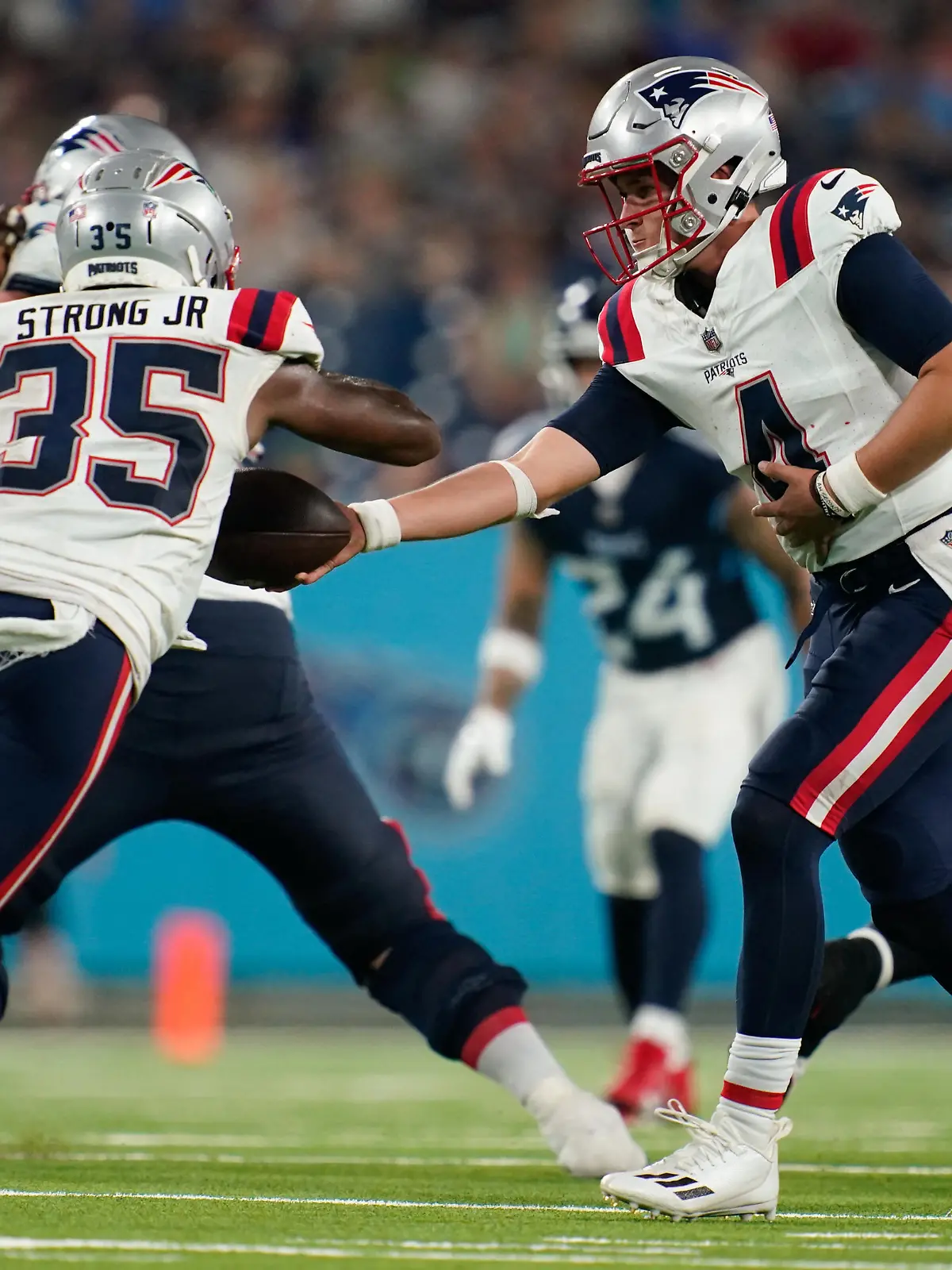 Aug 25, 2023; Nashville, Tennessee, USA; New England Patriots quarterback Bailey Zappe (4) hands the ball to running back Pierre Strong Jr. (35) during the third quarter against the New England Patriots at Nissan Stadium. Mandatory Credit: Andrew Nelles-USA TODAY Sports