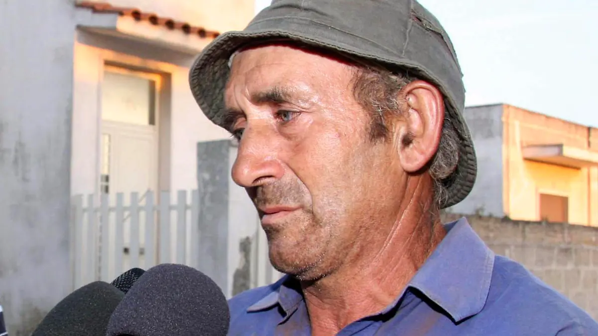In this Sept. 29, 2010 photo Michele Misseri answers reporters' questions in Avetrana, Southern Italy. An Italian mother whose anguish over her missing daughter gripped the nation for weeks was told on live TV that the teenager had been slain, allegedly by the girl's uncle, Misseri, whose house was hosting the show. Concetta Serrano, looking like she was in shock, murmured "my brother-in-law is innocent," and "I can't believe it" as she sat in the dining room of the uncle's house. The TV anchor of a popular show about missing person cases on RAI state TV told her late Wednesday night the breaking news that "one of the persons" being interrogated by police in Taranto, southern Italy, had allegedly confessed to killing Sarah Scazzi, 15, and that the body had been found. While much of the nation watched, calls were made to the cell phone of the uncle, Michele Misseri, who, along with his wife, Serrano's sister, had been interrogated for hours and was still being questioned. Taranto Prosecutor Franco Sebastio told a news conference that police had pulled out the waterlogged body of a blond girl resembling Sarah out of a cistern Thursday after Misseri had led them to a spot covered by stones, dirt and leaves. (AP Photo/Donato Fasano)
