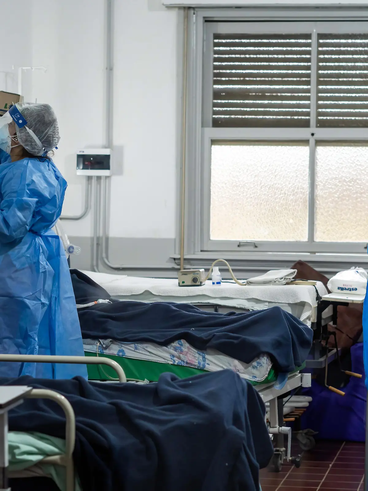 May 19, 2021, Firmat, Santa Fe, Argentina: A nurse wearing a Personal Protective Equipment suite (PPE) checks on infected patients inside the covid-19 intensive care unit (ICU) in Hospital San Martin..The second wave of COVID-19 is hitting hard, with the country reaching record of deaths and contagions, the health system of the Province of Santa Fe has 90% of occupation, and both Federal and Provincial Governments have placed strict restrictions to try to control de virus spread. (Credit Image: © Patricio Murphy/SOPA Images via ZUMA Wire