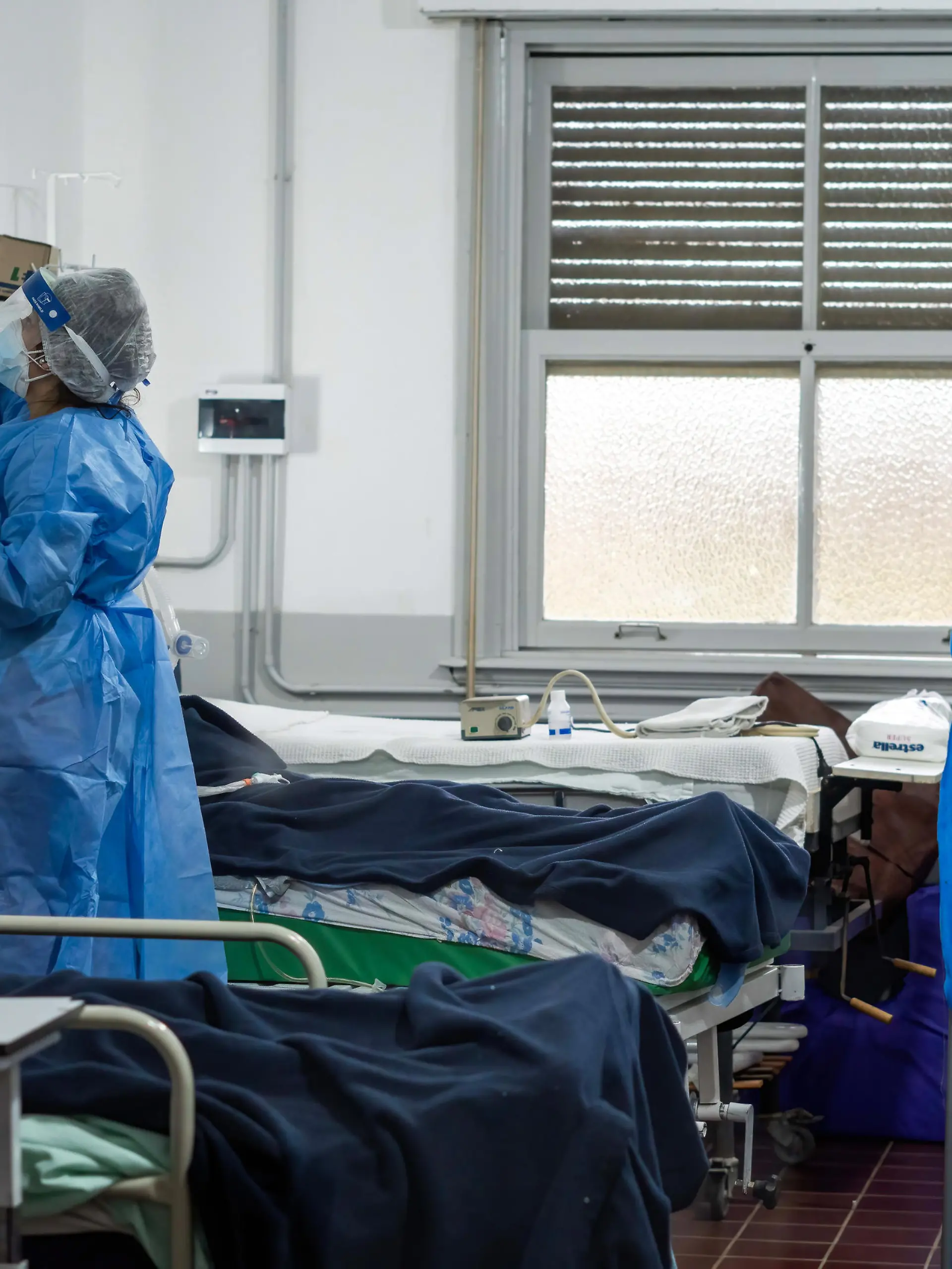 May 19, 2021, Firmat, Santa Fe, Argentina: A nurse wearing a Personal Protective Equipment suite (PPE) checks on infected patients inside the covid-19 intensive care unit (ICU) in Hospital San Martin..The second wave of COVID-19 is hitting hard, with the country reaching record of deaths and contagions, the health system of the Province of Santa Fe has 90% of occupation, and both Federal and Provincial Governments have placed strict restrictions to try to control de virus spread. (Credit Image: © Patricio Murphy/SOPA Images via ZUMA Wire