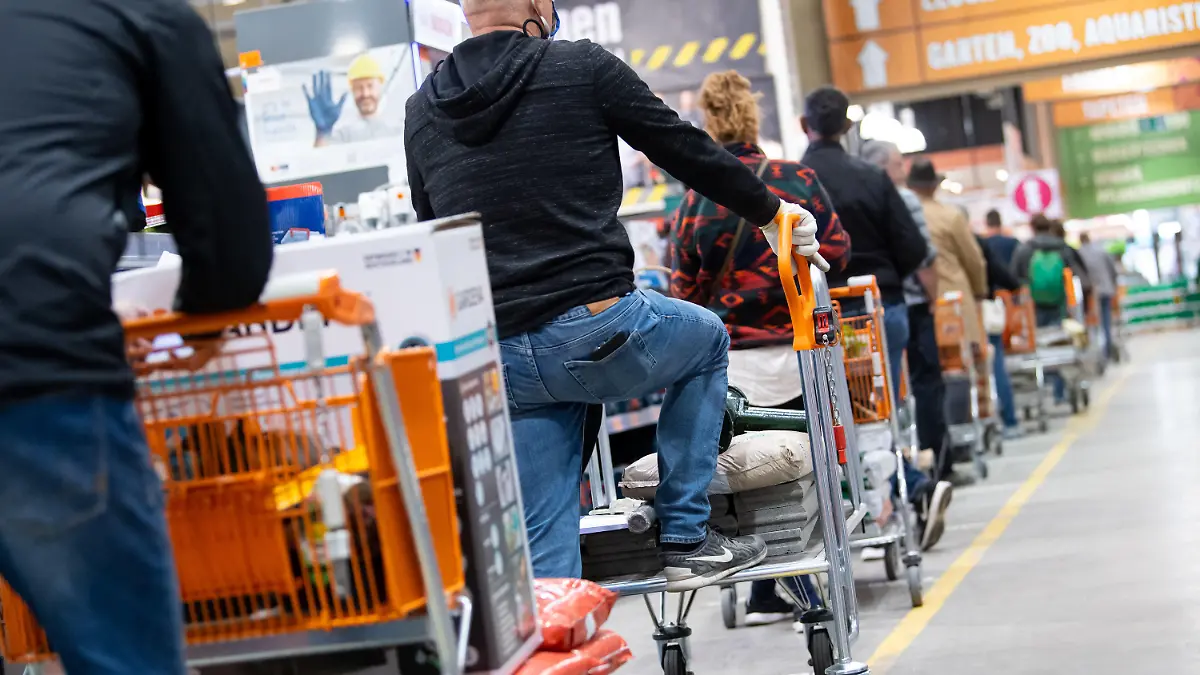 ARCHIV - 20.04.2020, Bayern, München: Kunden stehen mit Einkaufswagen in einem Hornbach-Baumarkt in einer Schlange vor den Kassen an. Die Corona-Krise beschert den Bau- und Gartenfachmärkten in Deutschland einen anhaltenden Nachfrageboom. (zu dpa "Baumärkte boomen in der Corona-Krise") Foto: Sven Hoppe/dpa +++ dpa-Bildfunk +++