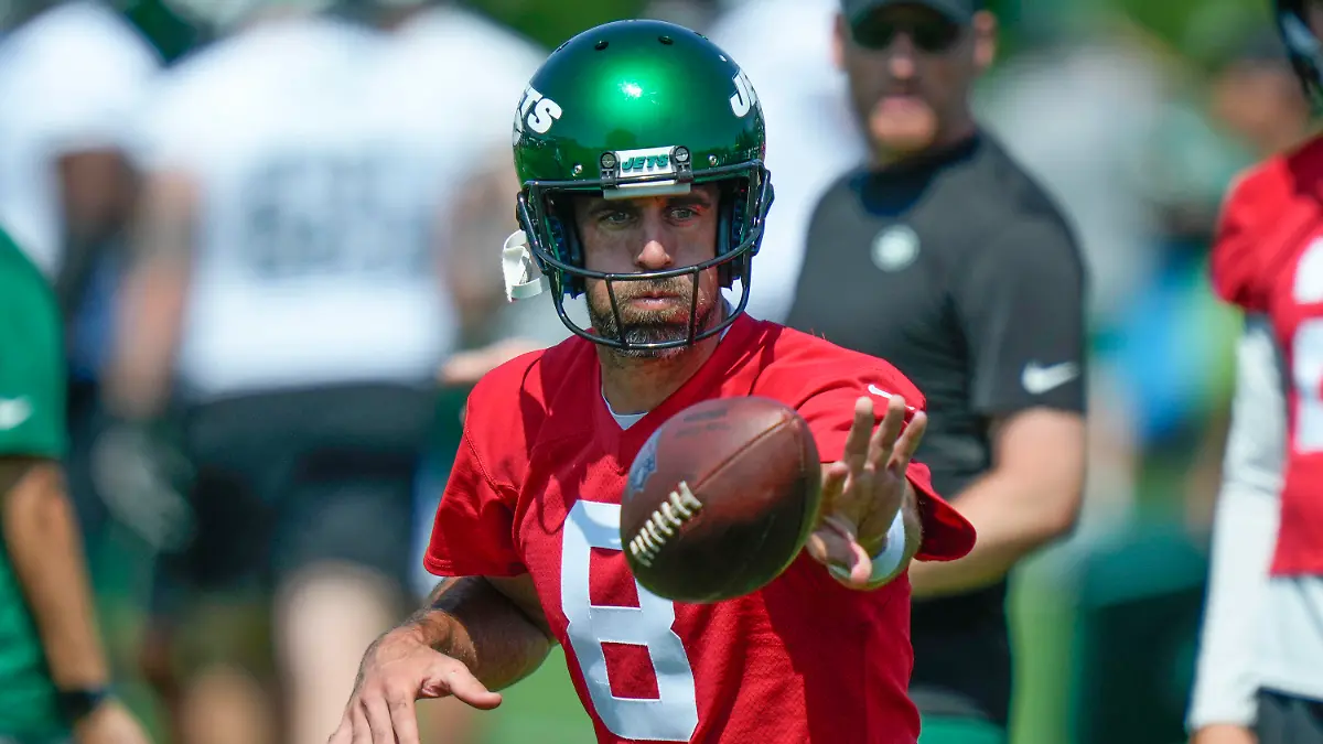 New York Jets quarterback Aaron Rodgers participates in a drill at the NFL football team's training facility in Florham Park, N.J., Sunday, July 23, 2023. (AP Photo/Seth Wenig)