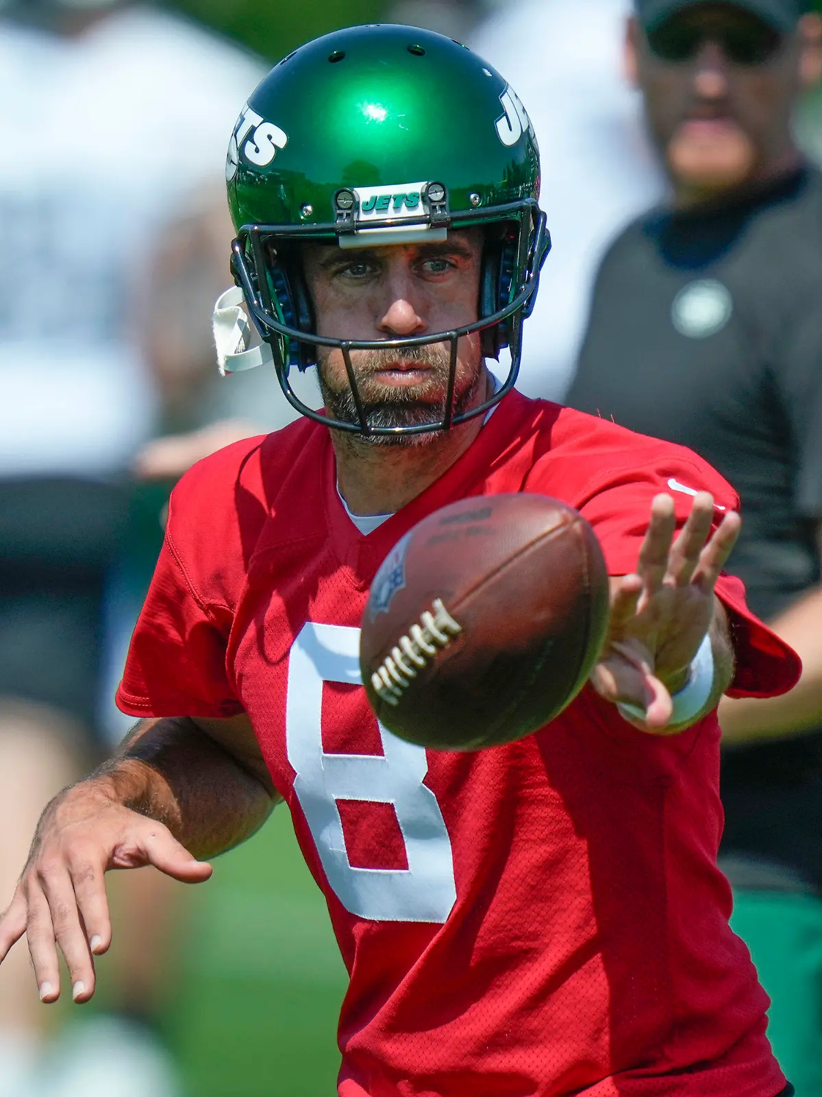 New York Jets quarterback Aaron Rodgers participates in a drill at the NFL football team's training facility in Florham Park, N.J., Sunday, July 23, 2023. (AP Photo/Seth Wenig)