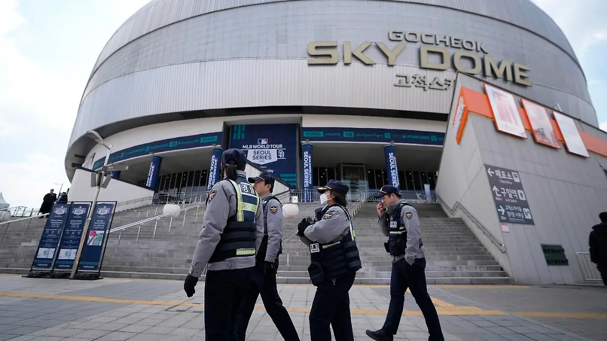 Police officers walk past in front of the Gocheok Sky Dome ahead of a game between the Los Angeles Dodgers and the San Diego Padres for the MLB World Tour Seoul Series in Seoul, South Korea, Wednesday, March 20, 2024. South Korean police said they’ve found no explosives at Seoul’s Gocheok Sky Dome after searching the site Wednesday following a reported bomb threat against Los Angeles Dodgers star Shohei Ohtani. (AP Photo/Lee Jin-man)