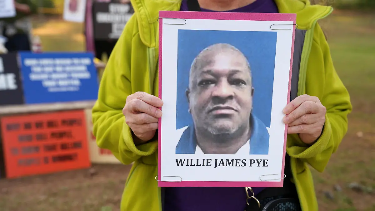 Cathy Harmon-Christian, the executive director of 'Georgians for Alternatives to the Death Penalty', holds a photo of Willie James Pye outside of the Georgia Diagnostic Prison in Jackson, Georgia, U.S. March 20, 2024. REUTERS/Jayla Whitfield-Anderson