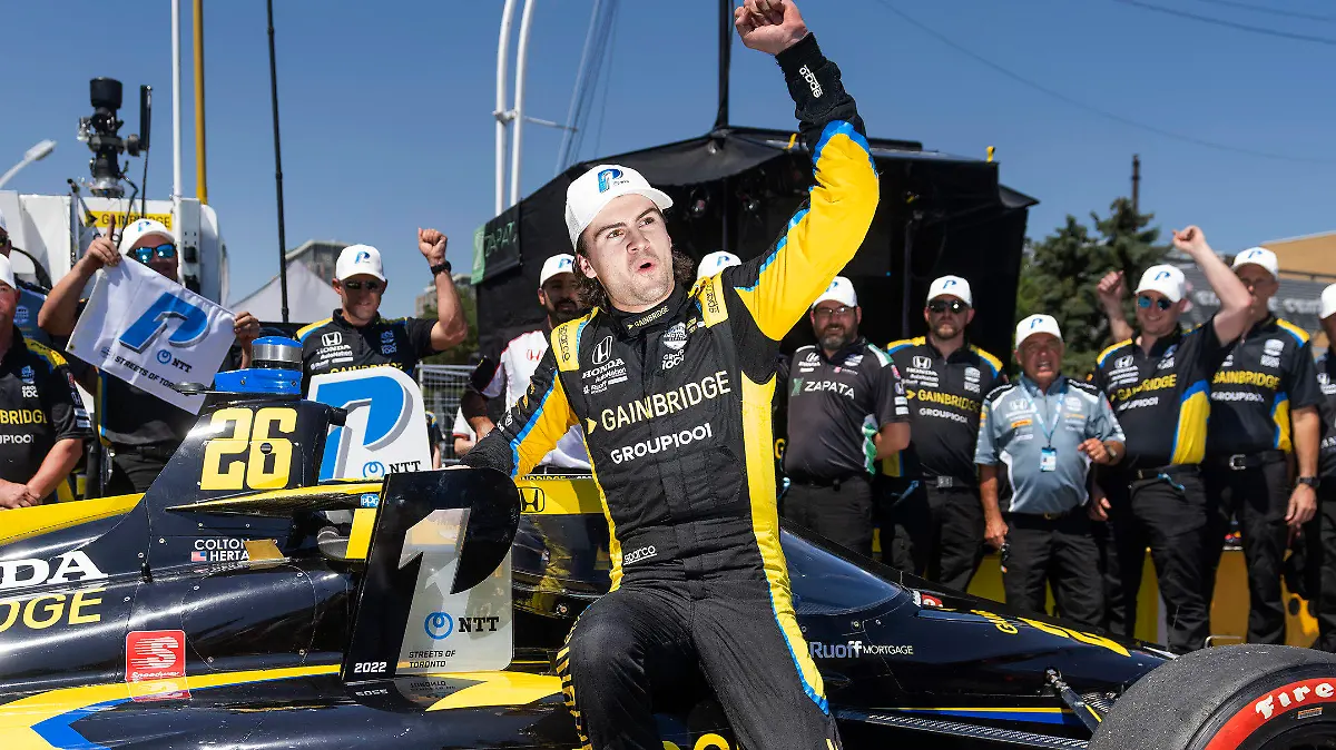 FILE - Colton Herta celebrates winning the pole position for the IndyCar Toronto auto race in Toronto, on July 16, 2022. Herta always wanted to be a race car driver and pursuing his passion came with parental conditions, among them the insistence that he learn to play a musical instrument. He learned the drums, started a band, and The Zibs played last week at one of Indianapolis' oldest bars. He doesn't have a gig scheduled for this weekend in Nashville: Herta is too focused on avenging his loss in last year's Music City Grand Prix. (Mark Blinch/The Canadian Press via AP, File)
