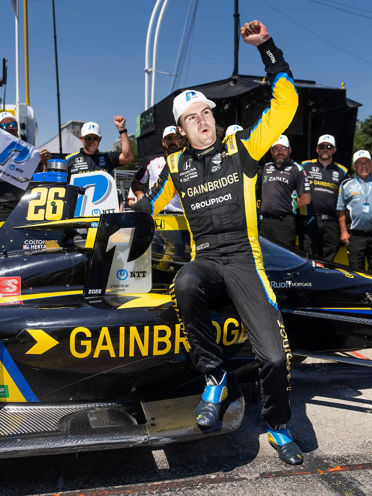FILE - Colton Herta celebrates winning the pole position for the IndyCar Toronto auto race in Toronto, on July 16, 2022. Herta always wanted to be a race car driver and pursuing his passion came with parental conditions, among them the insistence that he learn to play a musical instrument. He learned the drums, started a band, and The Zibs played last week at one of Indianapolis' oldest bars. He doesn't have a gig scheduled for this weekend in Nashville: Herta is too focused on avenging his loss in last year's Music City Grand Prix. (Mark Blinch/The Canadian Press via AP, File)