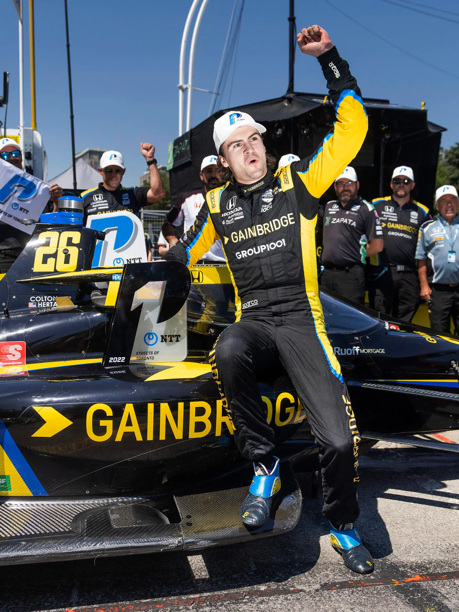 FILE - Colton Herta celebrates winning the pole position for the IndyCar Toronto auto race in Toronto, on July 16, 2022. Herta always wanted to be a race car driver and pursuing his passion came with parental conditions, among them the insistence that he learn to play a musical instrument. He learned the drums, started a band, and The Zibs played last week at one of Indianapolis' oldest bars. He doesn't have a gig scheduled for this weekend in Nashville: Herta is too focused on avenging his loss in last year's Music City Grand Prix. (Mark Blinch/The Canadian Press via AP, File)