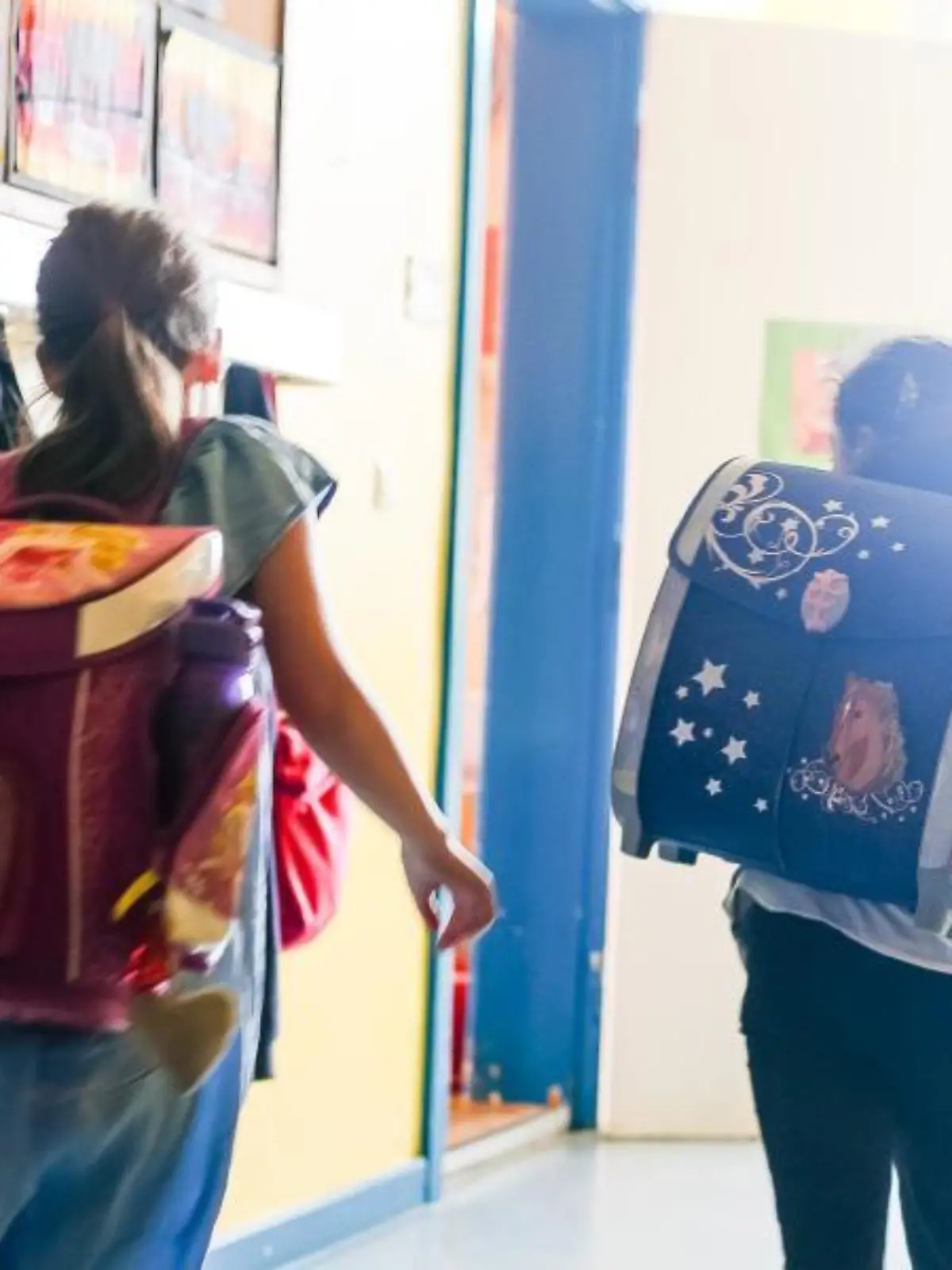 Zwei Schulkinder laufen in den Klassenraum