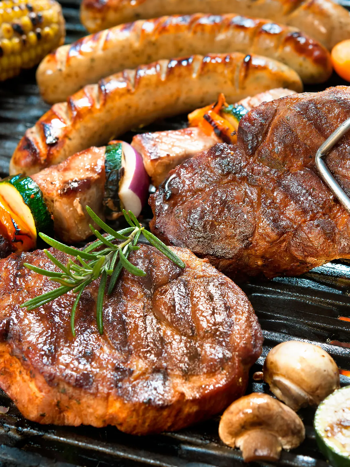 Assorted delicious grilled meat with vegetable over the coals on a barbecue