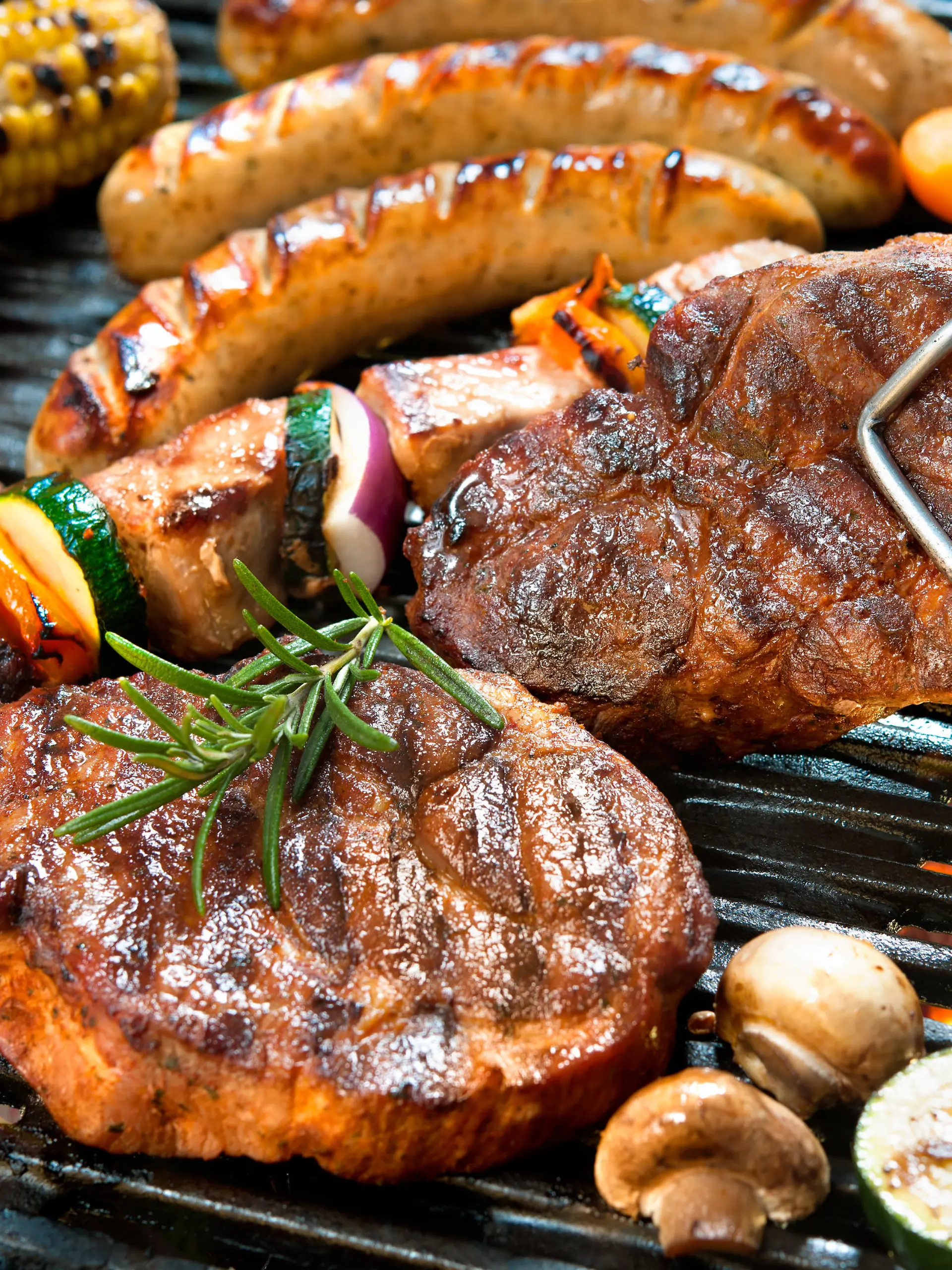 Assorted delicious grilled meat with vegetable over the coals on a barbecue