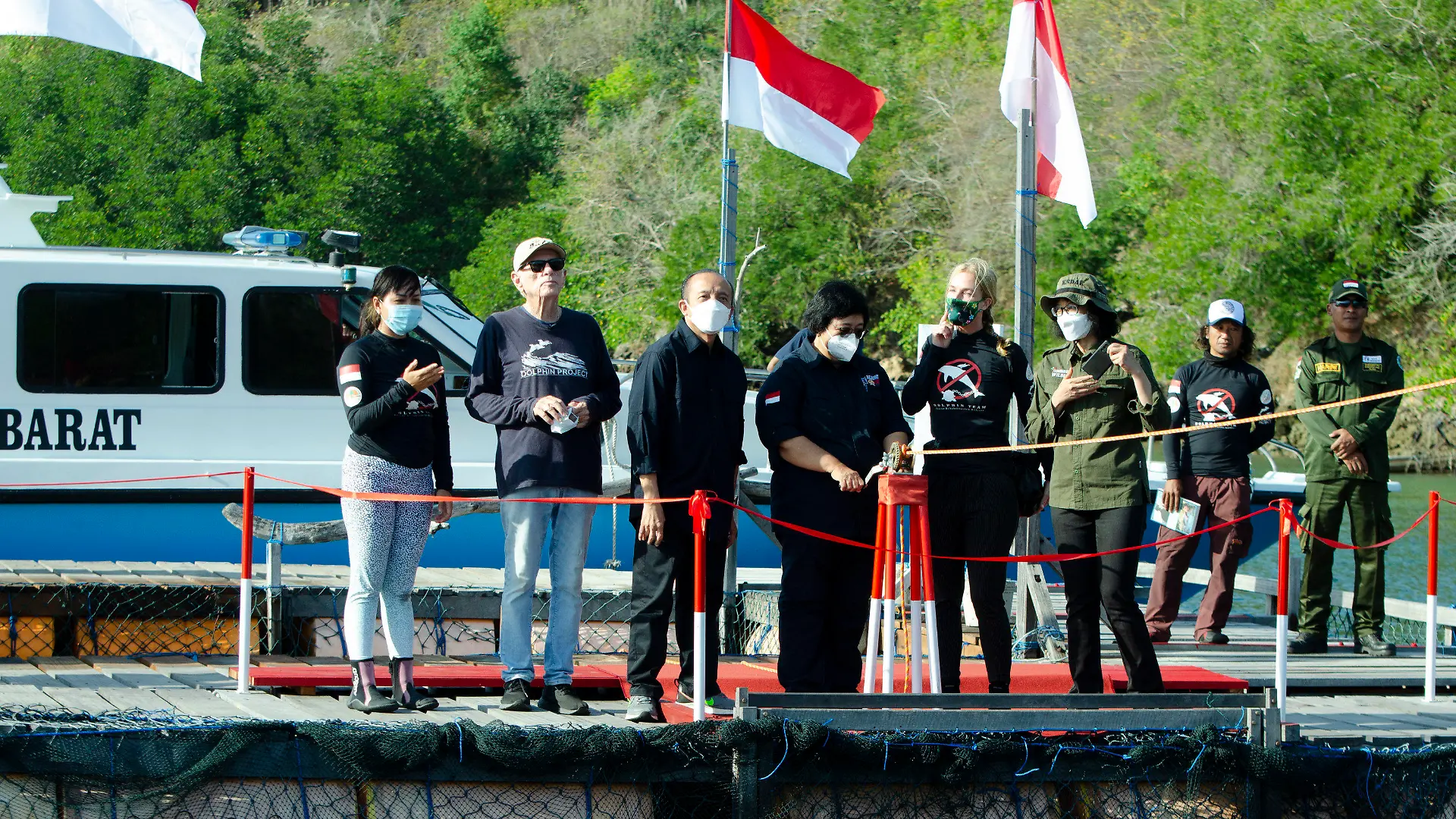 Indonesian Environment and Forestry Minister Siti Nurbaya Bakar, center, officially opens the gates to release rescued dolphins Rocky, Rambo and Johnny back into the wild in Banyuwedang Bay, West Bali, Indonesia Saturday, Sept. 3, 2022. Three bottlenose dolphins were released into the open sea in Indonesia Saturday after years of being confined for the amusement of tourists who would touch and swim with them. (DolphinProject.com via AP)