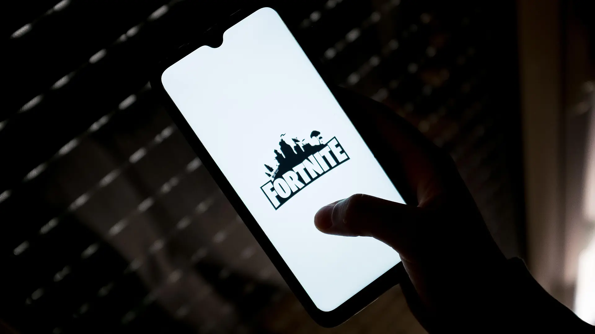 In this photo illustration a Fortnite logo seen displayed on a smartphone screen in Athens, Greece on May 11, 2022. (Photo illustration by Nikolas Kokovlis/NurPhoto)
