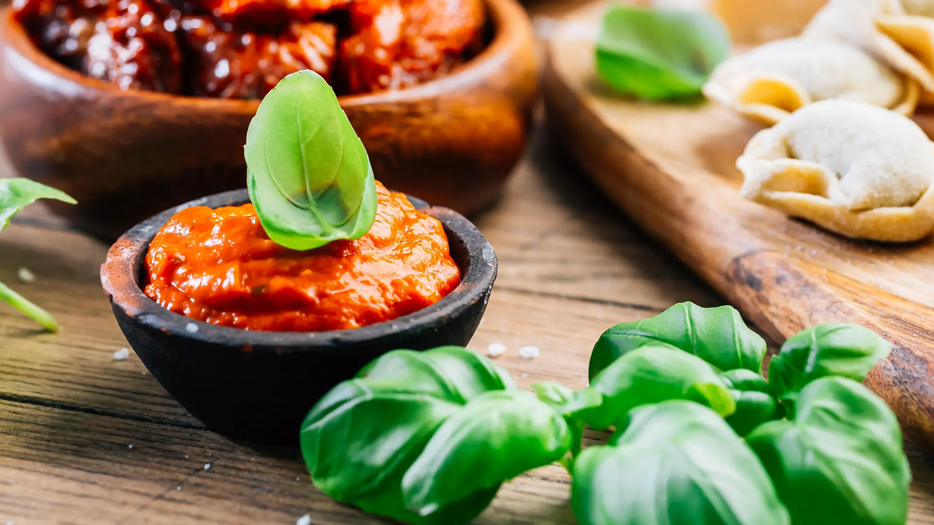 Home cooking - raw tortellini pasta with tomato pesto and sun-dried tomatoes and basil