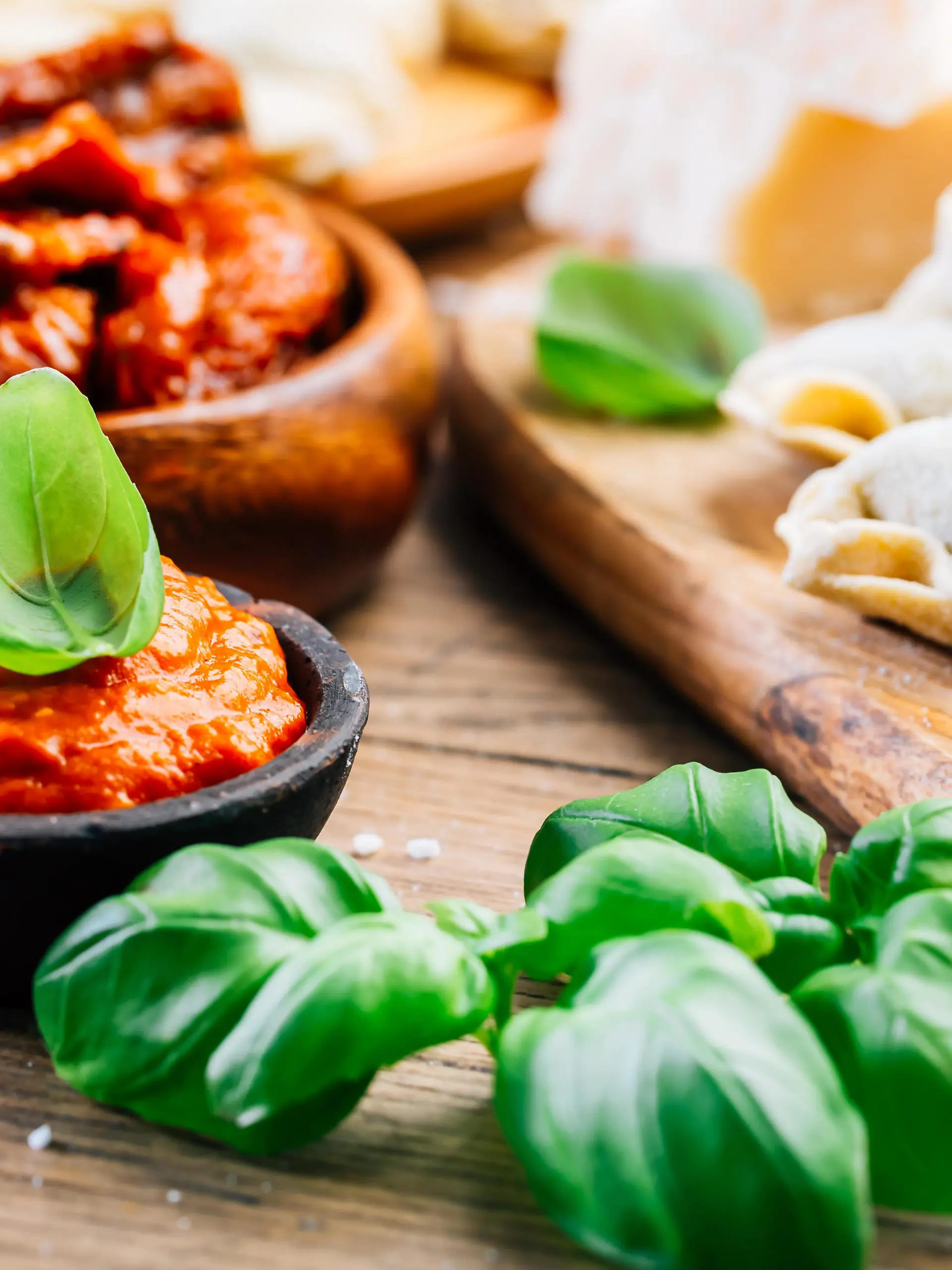 Home cooking - raw tortellini pasta with tomato pesto and sun-dried tomatoes and basil