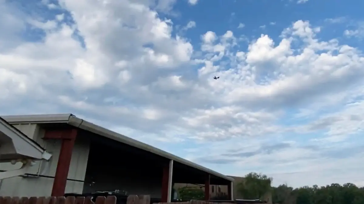 A small airplane circles over Tupelo, Miss., on Saturday, Sept. 3, 2022.  Police say the pilot of the small airplane is threatening to crash the aircraft into a Walmart store. The Tupelo Police Department said that the Walmart and a nearby convenience store had been evacuated. (Rachel McWilliams via AP)