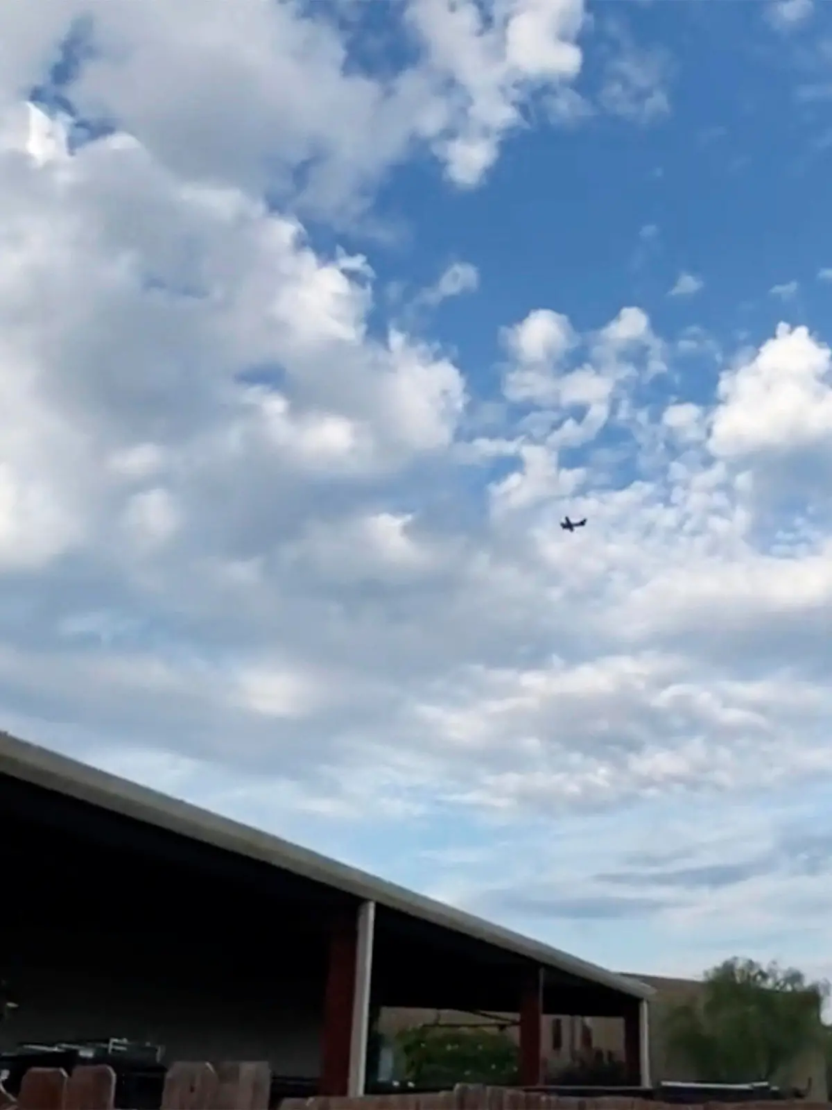 A small airplane circles over Tupelo, Miss., on Saturday, Sept. 3, 2022.  Police say the pilot of the small airplane is threatening to crash the aircraft into a Walmart store. The Tupelo Police Department said that the Walmart and a nearby convenience store had been evacuated. (Rachel McWilliams via AP)