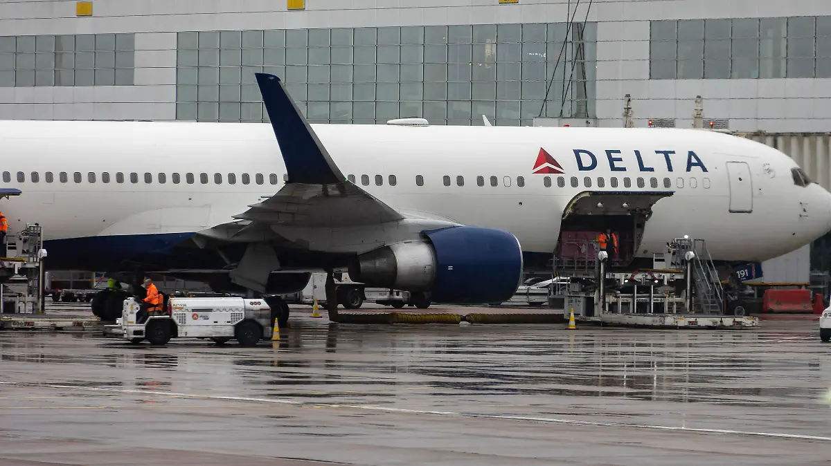 Delta Air Lines Boeing 767-300(WL) at Brussels Airport, IATA: BRU, ICAO: EBBR, also informally called Brussels-National Airport or Brussels-Zaventem Airport during a rainy day with dark clouds. The Boeing 767 wide-body passenger plane with winglets of Delta Airlines carrier has the registration N191DN and is powered by 2x PW jet engines. Delta or DAL is a major airline of the United States, a legacy carrier with headquarters in Atlanta, Georgia member of SkyTeam aviation alliance. Delta is the second largest airline in the world by passenger traffic and fleet size. The current Boeing 767 docked at the airport terminal is preparing for departure to New York, USA with flight number DL141 while airport workers load luggage and cargo. Brussels, Belgium on September 2023 (Photo by Nicolas Economou/NurPhoto)