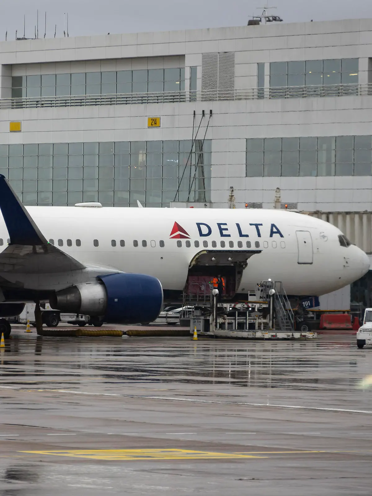 Delta Air Lines Boeing 767-300(WL) at Brussels Airport, IATA: BRU, ICAO: EBBR, also informally called Brussels-National Airport or Brussels-Zaventem Airport during a rainy day with dark clouds. The Boeing 767 wide-body passenger plane with winglets of Delta Airlines carrier has the registration N191DN and is powered by 2x PW jet engines. Delta or DAL is a major airline of the United States, a legacy carrier with headquarters in Atlanta, Georgia member of SkyTeam aviation alliance. Delta is the second largest airline in the world by passenger traffic and fleet size. The current Boeing 767 docked at the airport terminal is preparing for departure to New York, USA with flight number DL141 while airport workers load luggage and cargo. Brussels, Belgium on September 2023 (Photo by Nicolas Economou/NurPhoto)