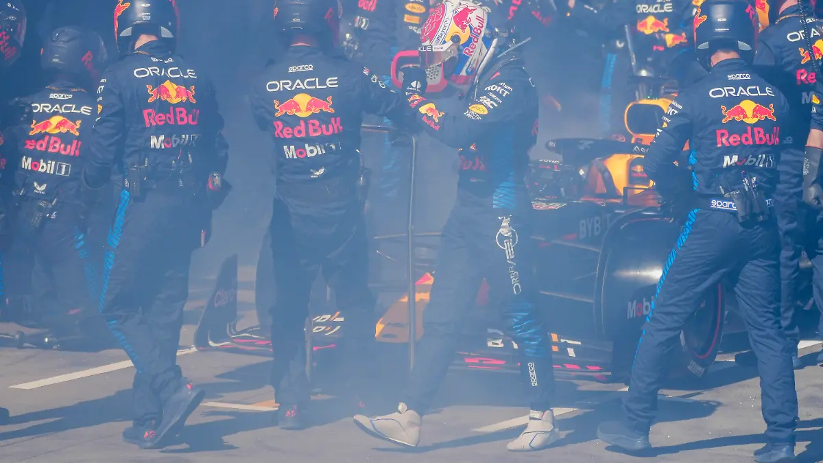 Red Bull driver Max Verstappen of the Netherlands walks from his car as it is enveloped in smoke as he retires from the Australian Formula One Grand Prix at Albert Park, in Melbourne, Australia, Sunday, March 24, 2024. (AP Photo/Scott Barbour,Pool)