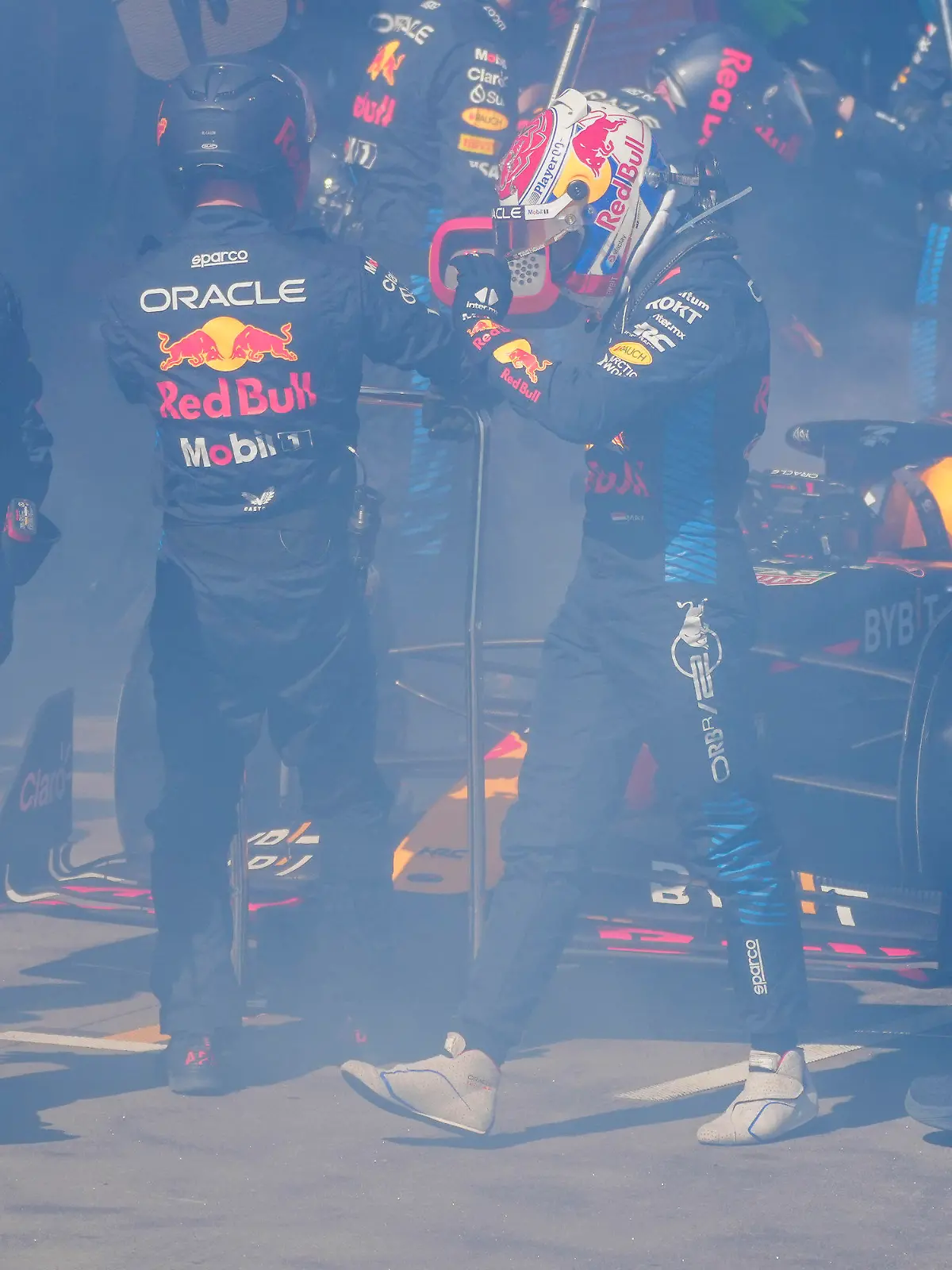 Red Bull driver Max Verstappen of the Netherlands walks from his car as it is enveloped in smoke as he retires from the Australian Formula One Grand Prix at Albert Park, in Melbourne, Australia, Sunday, March 24, 2024. (AP Photo/Scott Barbour,Pool)