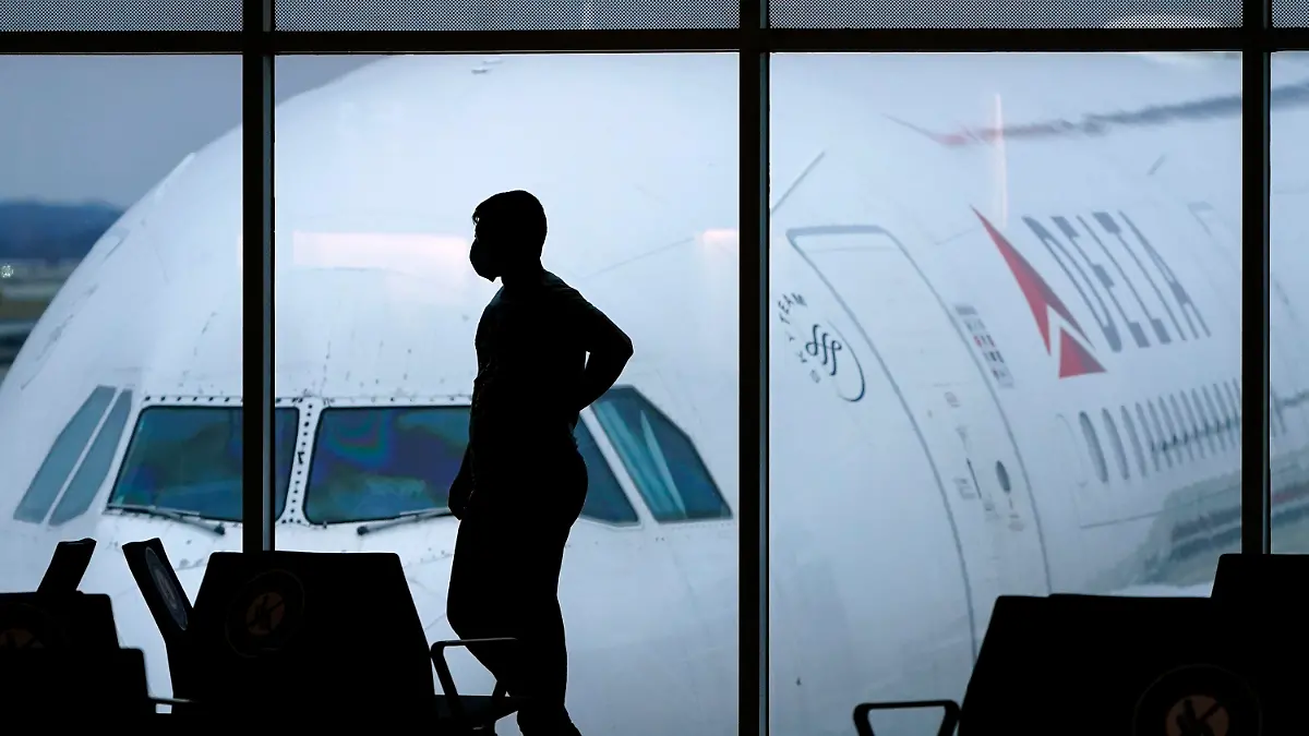 FILE - A passenger waits for a Delta Airlines flight at Hartsfield-Jackson International Airport in Atlanta on Feb. 18, 2021. The U.S. Department of Transportation said Thursday, March 21, 2024, that it will review how airlines protect personal information about their passengers and whether they are making money by sharing that information with other parties. (AP Photo/Charlie Riedel, File)