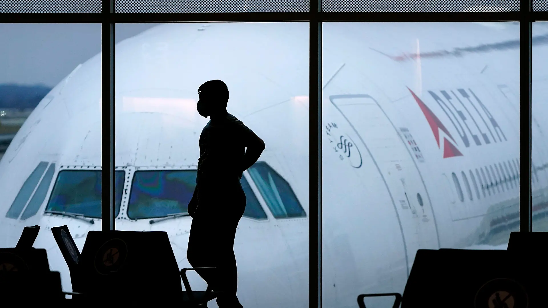 FILE - A passenger waits for a Delta Airlines flight at Hartsfield-Jackson International Airport in Atlanta on Feb. 18, 2021. The U.S. Department of Transportation said Thursday, March 21, 2024, that it will review how airlines protect personal information about their passengers and whether they are making money by sharing that information with other parties. (AP Photo/Charlie Riedel, File)