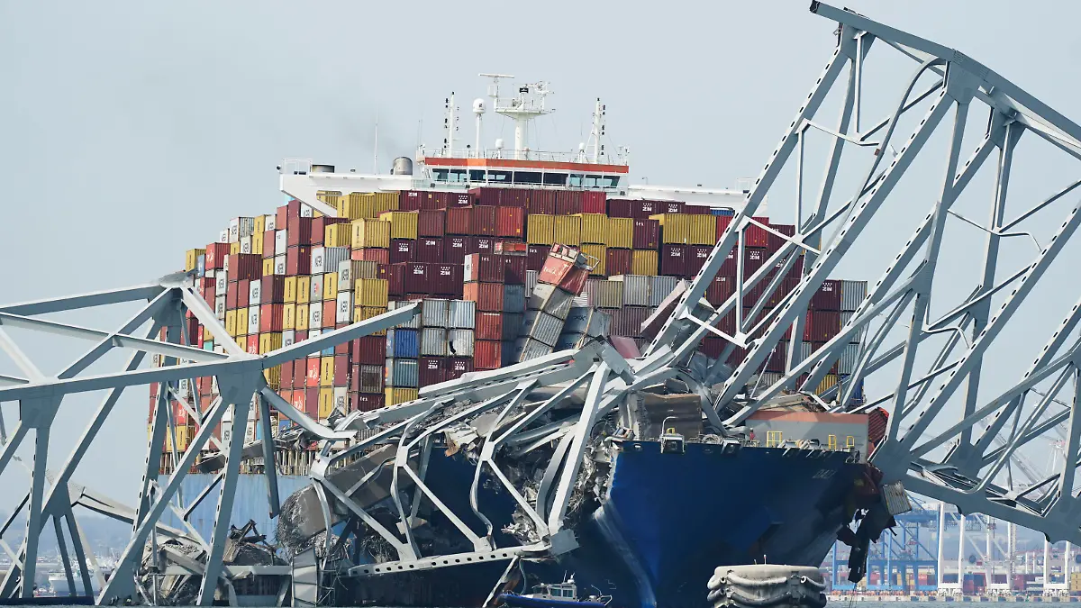 A Coast Guard cutter passes a cargo ship that is stuck under the part of the structure of the Francis Scott Key Bridge after the ship his the bridge Tuesday, March 26, 2024, in Baltimore, Md. (AP Photo/Steve Helber)