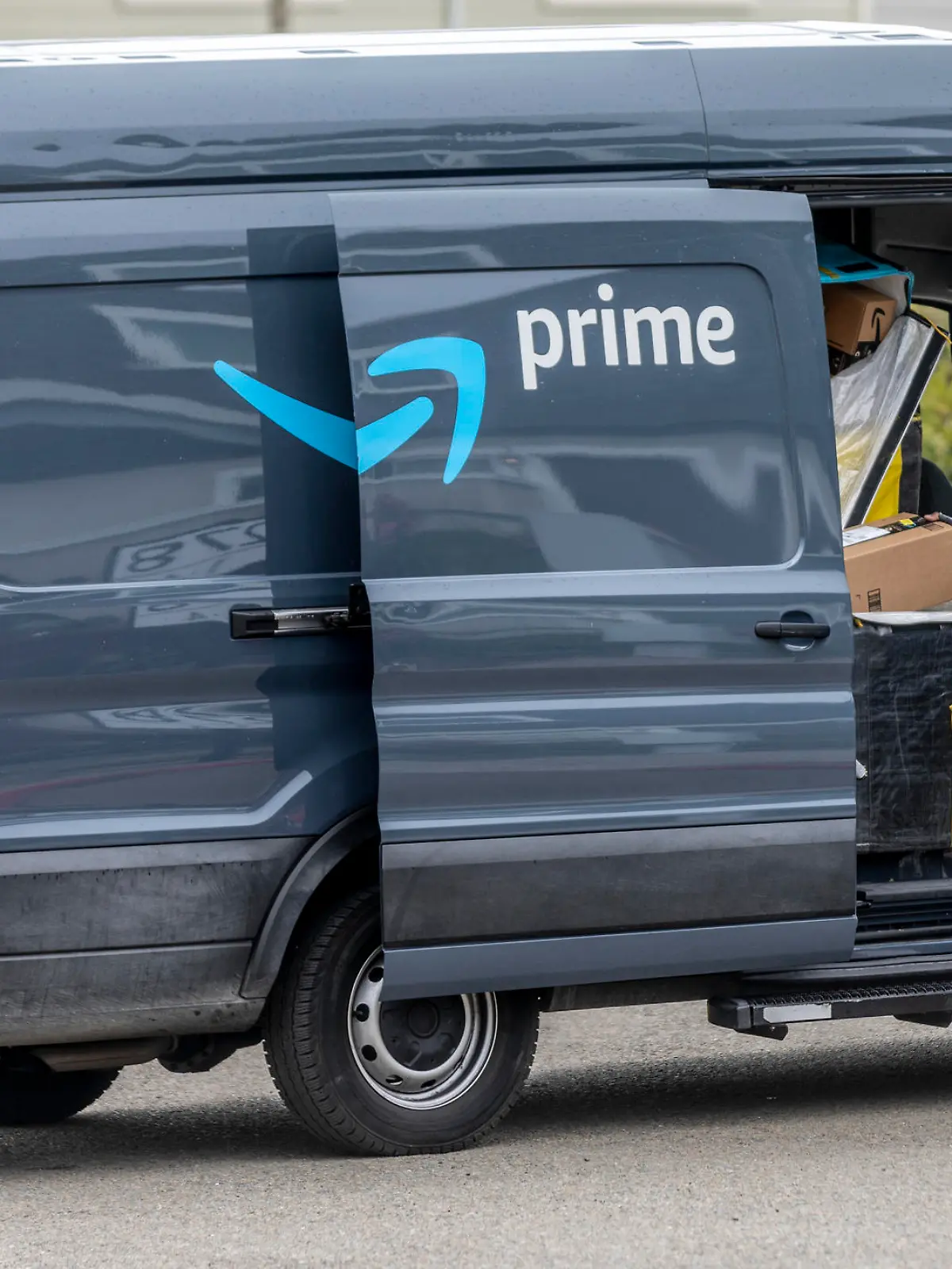Pacifica California, USA - May 11, 2020: An Amazon Prime delivery driver wearing personal protective equipment delivers packages during the shelter in place order and quarantine.