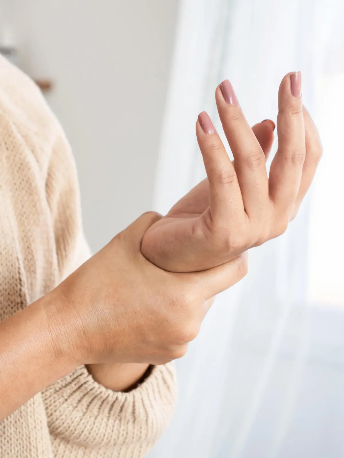 woman suffering from wrist pain, numbness, or Carpal tunnel syndrome hand holding her ache joint