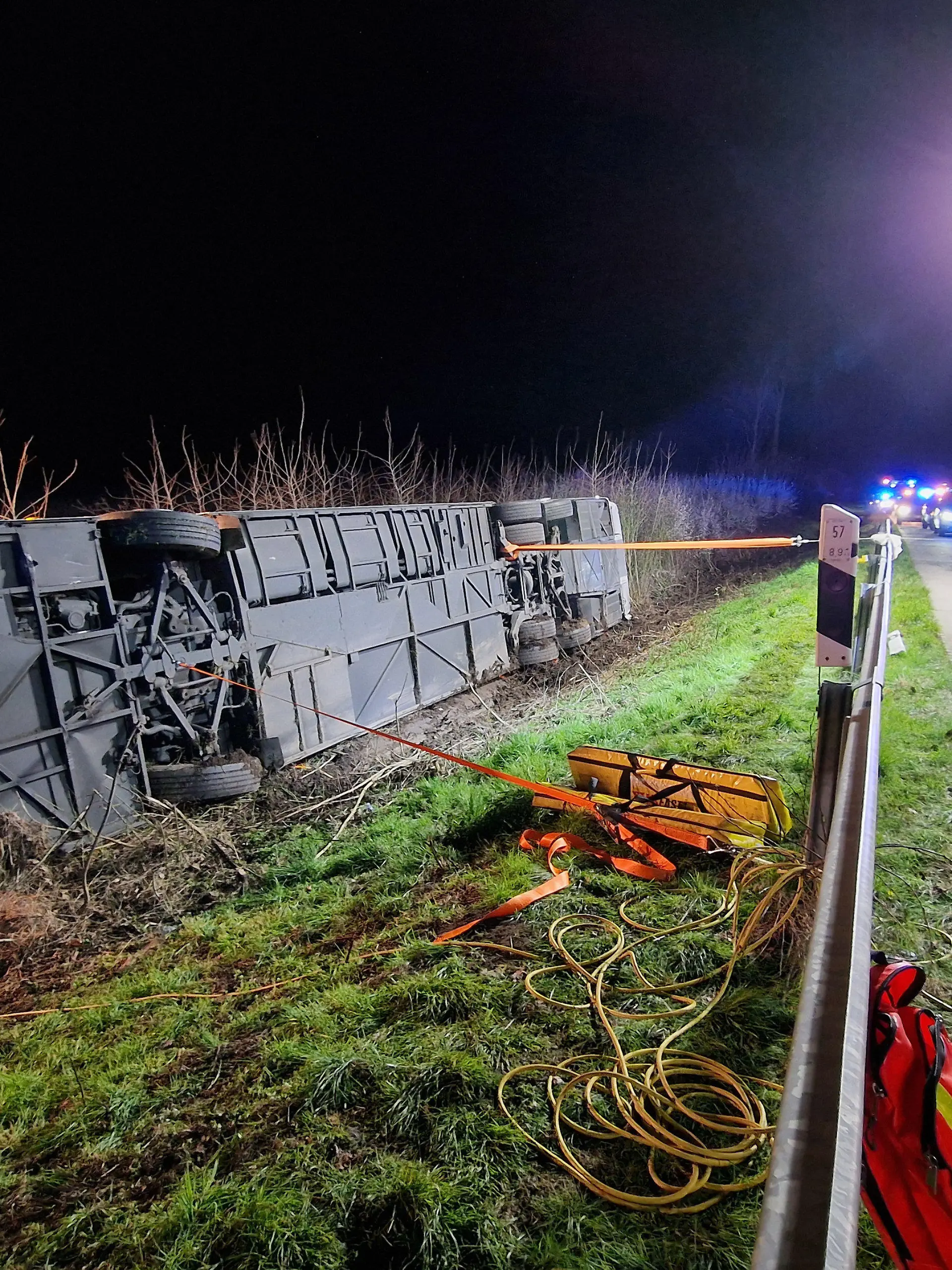 29.03.2024, Nordrhein-Westfalen, Werl: Ein Bus liegt nach einem Unfall auf der Seite an der Autobahn 44 (A44). Ein Reisebus mit rund 60 Fahrgästen ist auf der Autobahn 44 in Nordrhein-Westfalen von der Fahrbahn abgekommen und auf die Seite gestürzt. Es handele sich nach bisherigen Kenntnissen um einen Unfall ohne Beteiligung weiterer Fahrzeuge, die Ursache sei noch unklar, teilte die Polizei in der Nacht zum Freitag mit. Ob es bei dem Unglück nahe Werl Verletzte gab, war zunächst unklar. Die A44 wurde von den Ausfahrten Unna Ost bis Werl in Fahrtrichtung Kassel voll gesperrt. Neben der Feuerwehr war auch ein Rettungshubschrauber im Einsatz. Foto: M. Neumann/Blaulicht Unna/dpa +++ dpa-Bildfunk +++