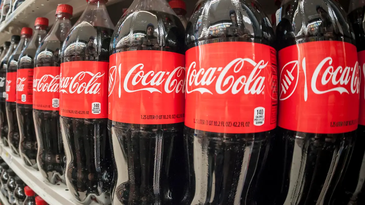 Bottles of Coca-Cola in a grocery store in New York on Monday, February 8, 2016. Coca-Cola reported a disappointing second-quarter as revenue fell globally and was only offset by a modest gain domestically. (© Richard B. Levine)