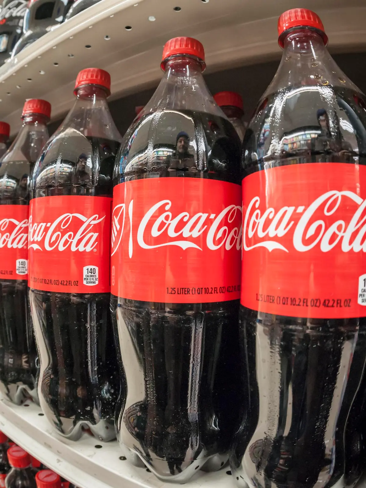 Bottles of Coca-Cola in a grocery store in New York on Monday, February 8, 2016. Coca-Cola reported a disappointing second-quarter as revenue fell globally and was only offset by a modest gain domestically. (© Richard B. Levine)